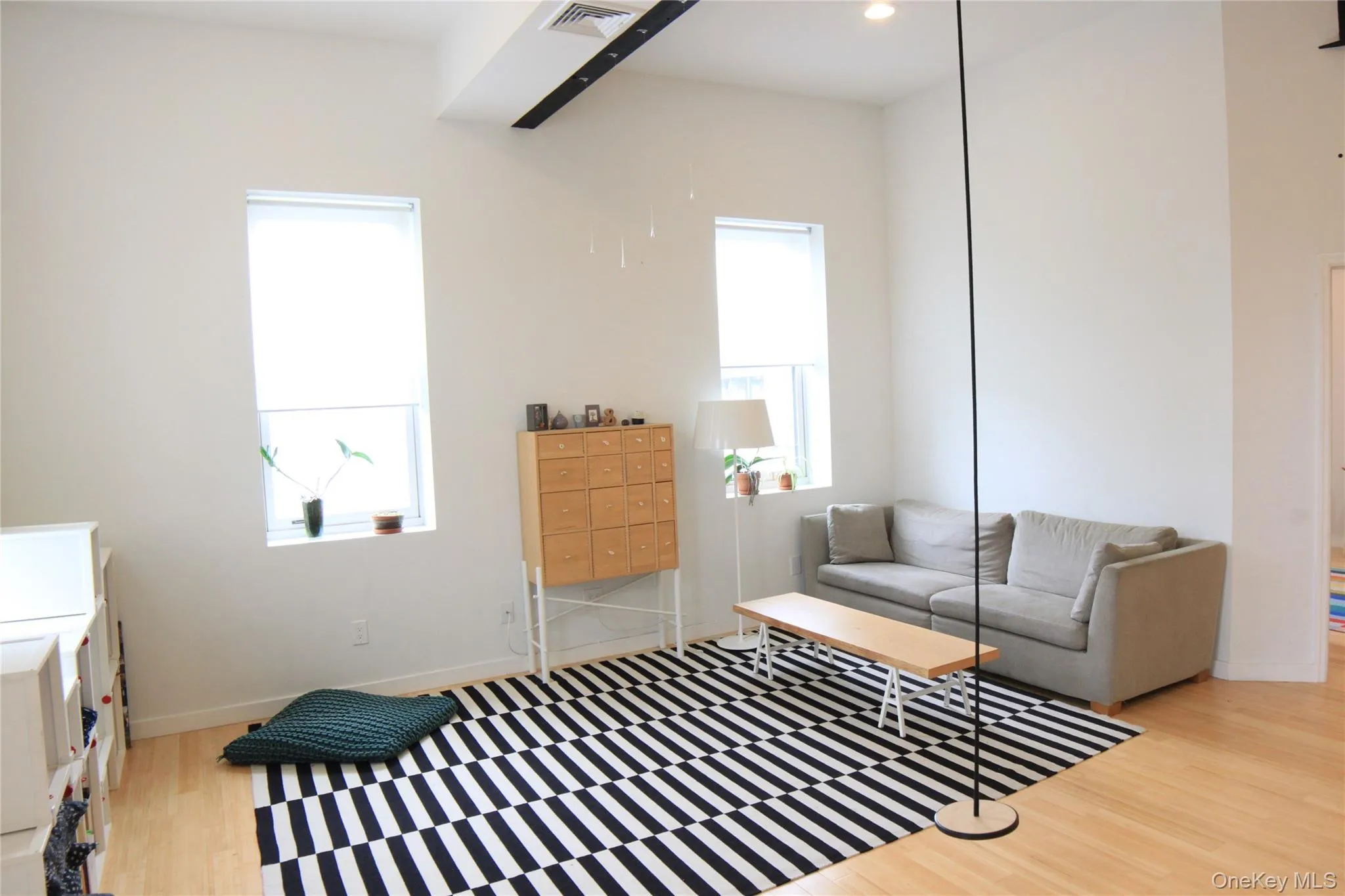 Living area with light wood finished floors and recessed lighting Living area with light wood finished floors and recessed lighting