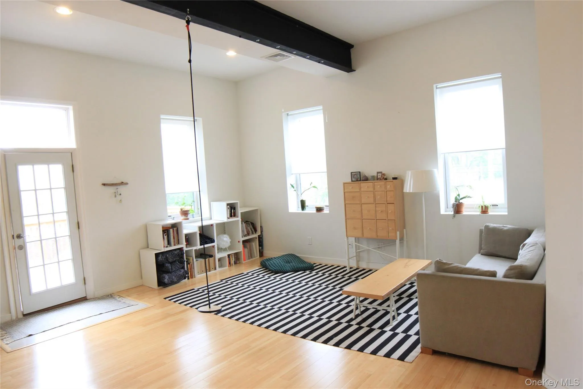 Living room with light wood finished floors and beam ceiling Living room with light wood finished floors and beam ceiling
