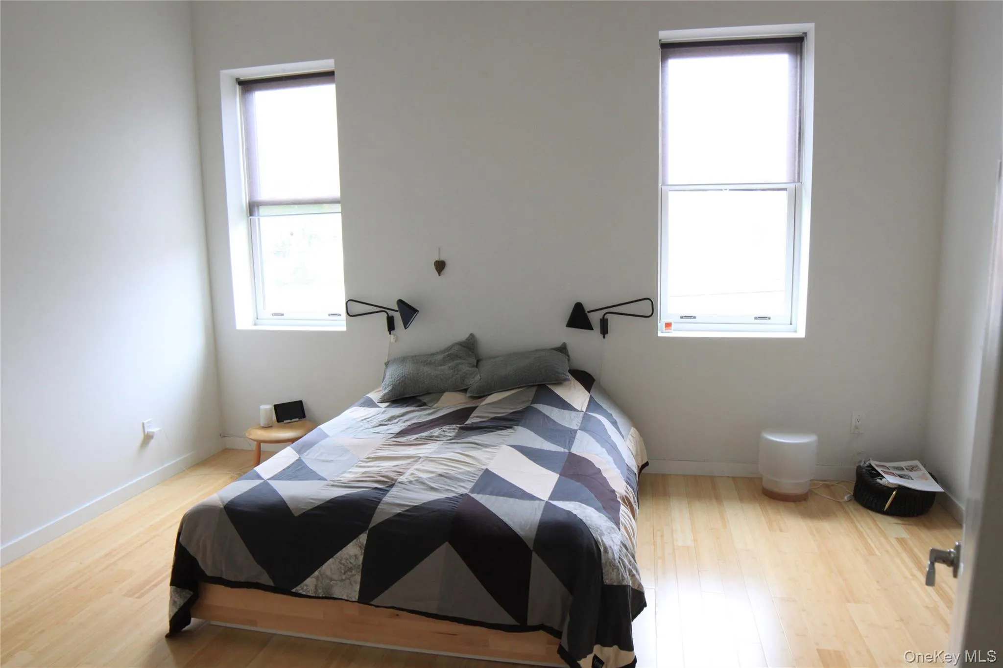 Bedroom with light wood finished floors and baseboards Bedroom with light wood finished floors and baseboards