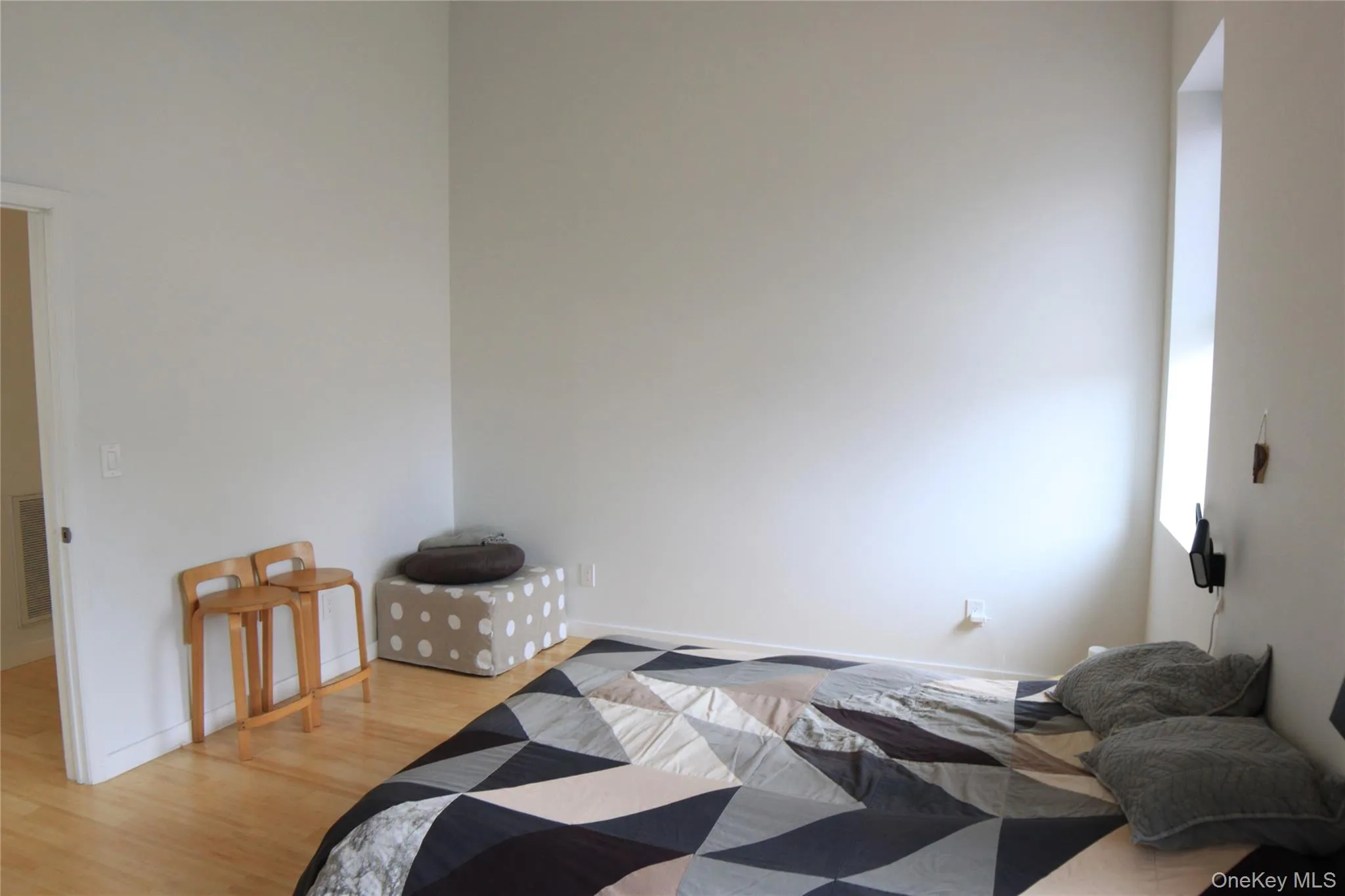 Bedroom featuring light wood-style floors and baseboards Bedroom featuring light wood-style floors and baseboards
