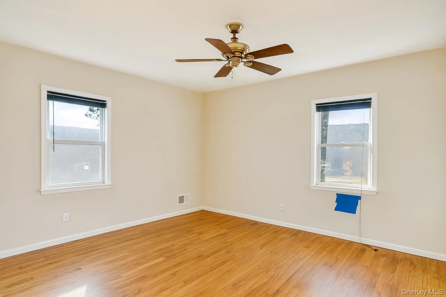 Spare room with light wood-style flooring and ceiling fan Spare room with light wood-style flooring and ceiling fan