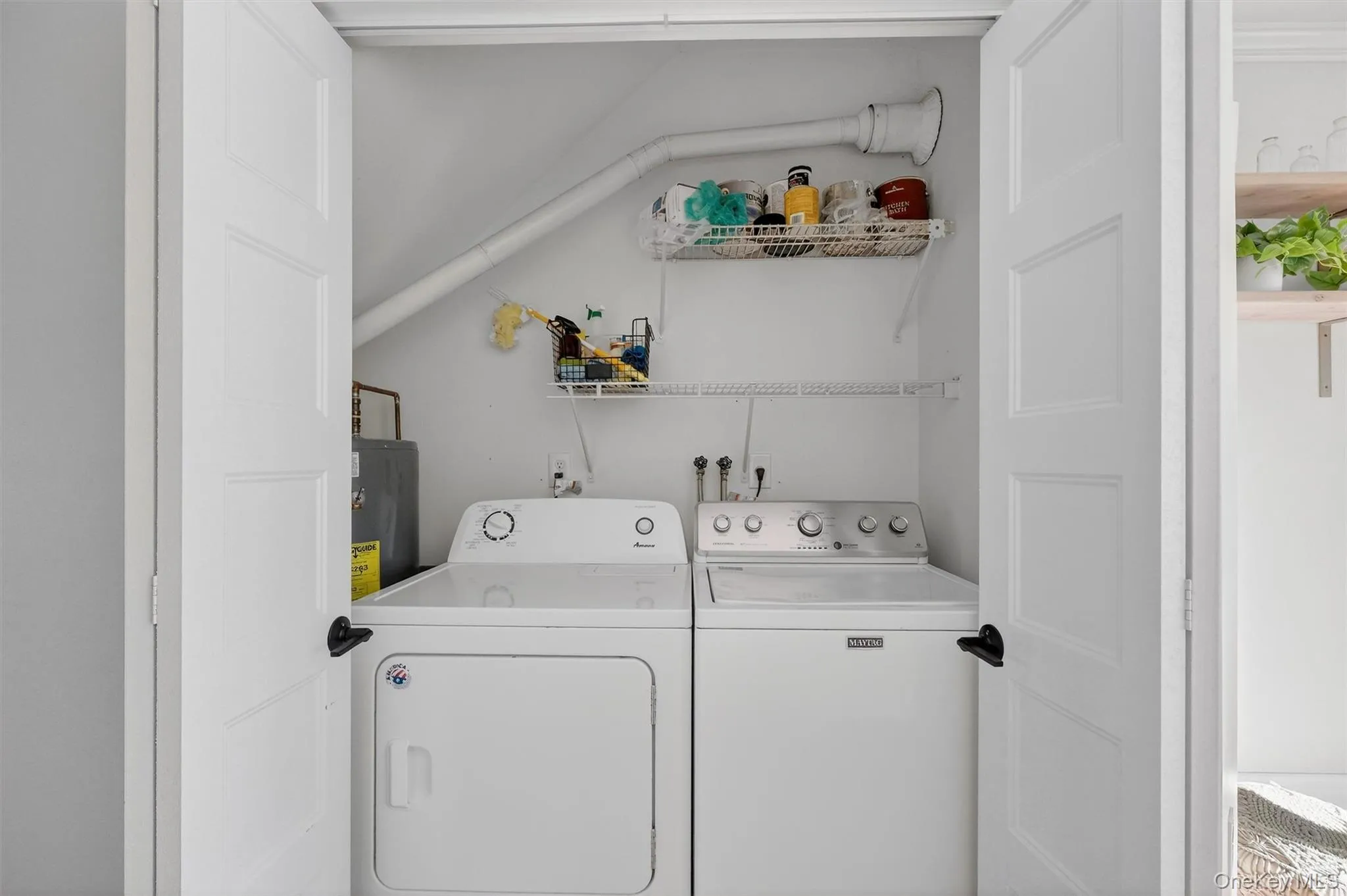 Laundry area with washing machine and dryer and water heater Laundry area with washing machine and dryer and water heater