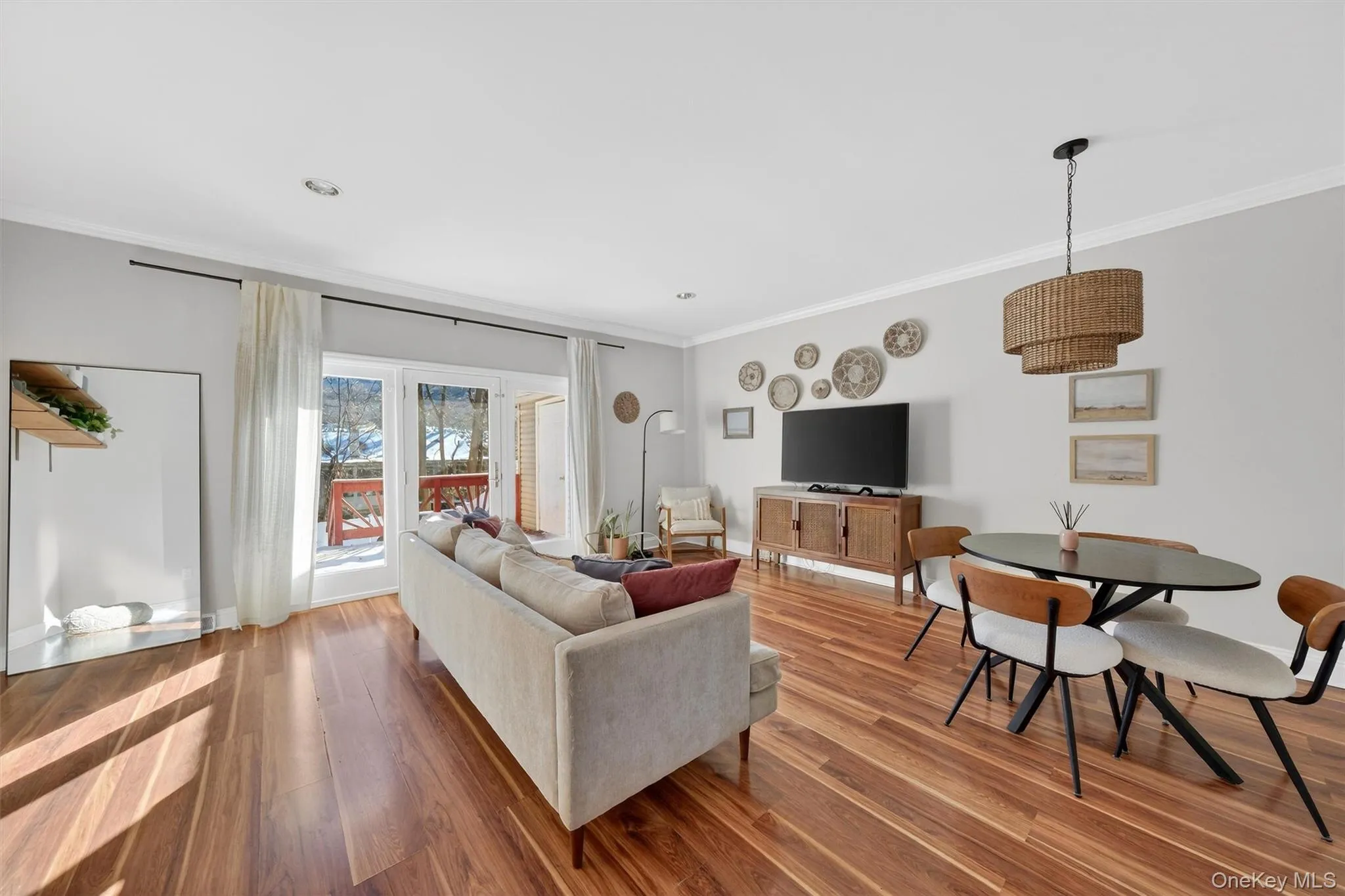 Living room featuring ornamental molding and wood finished floors Living room featuring ornamental molding and wood finished floors