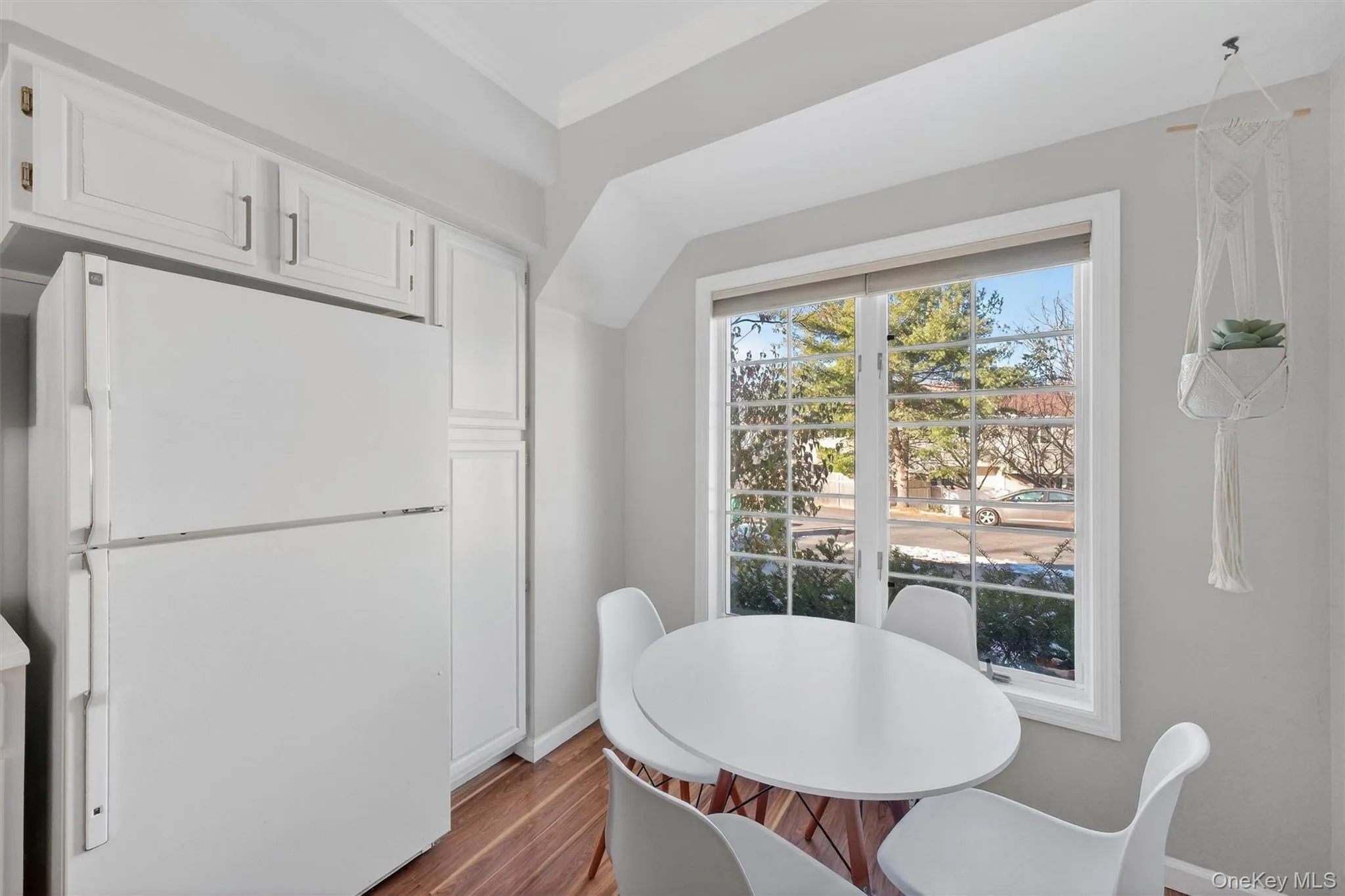 Dining area with wood finished floors and ornamental molding Dining area with wood finished floors and ornamental molding