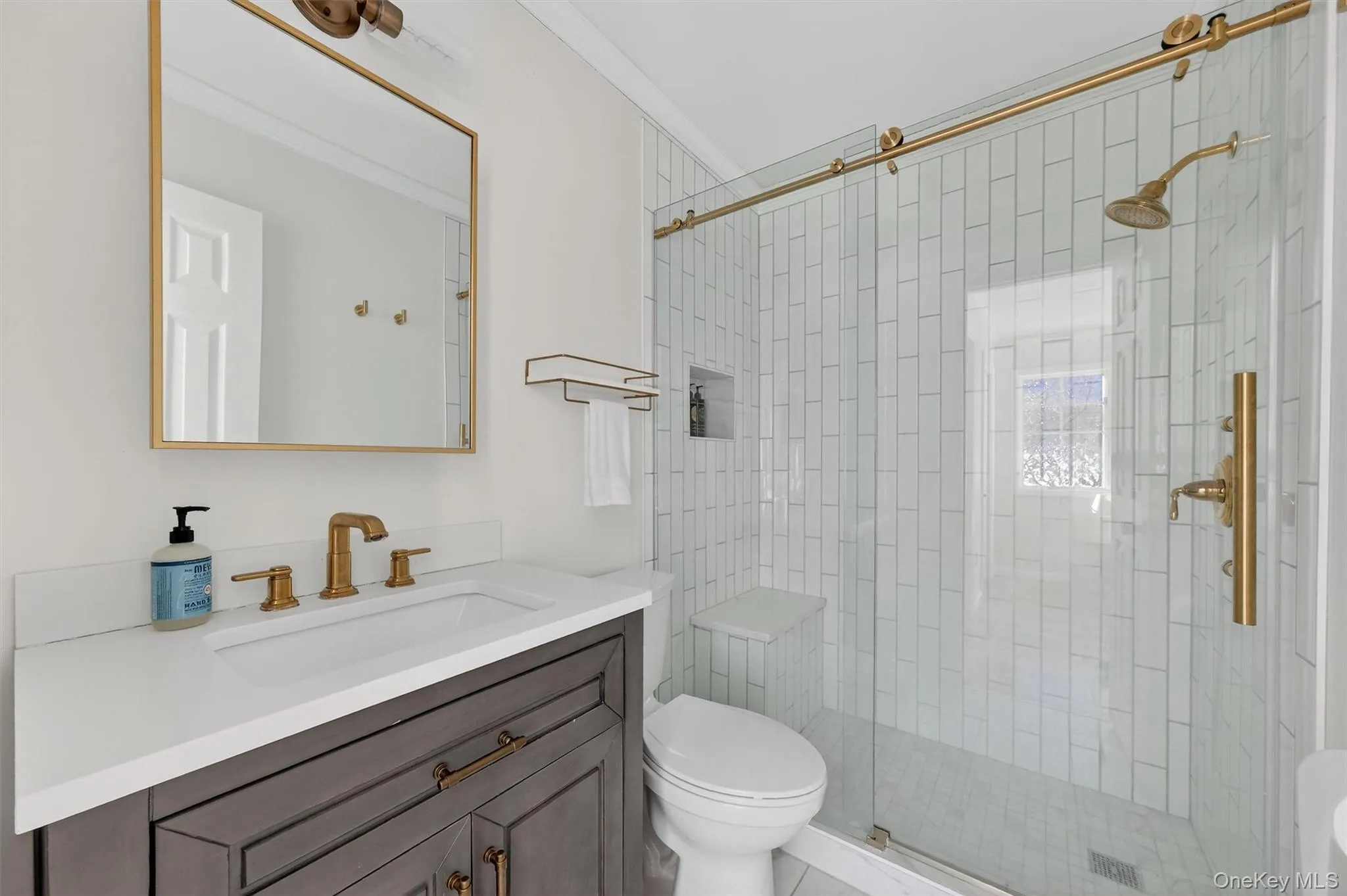 Bathroom featuring vanity, a stall shower, and crown molding Bathroom featuring vanity, a stall shower, and crown molding