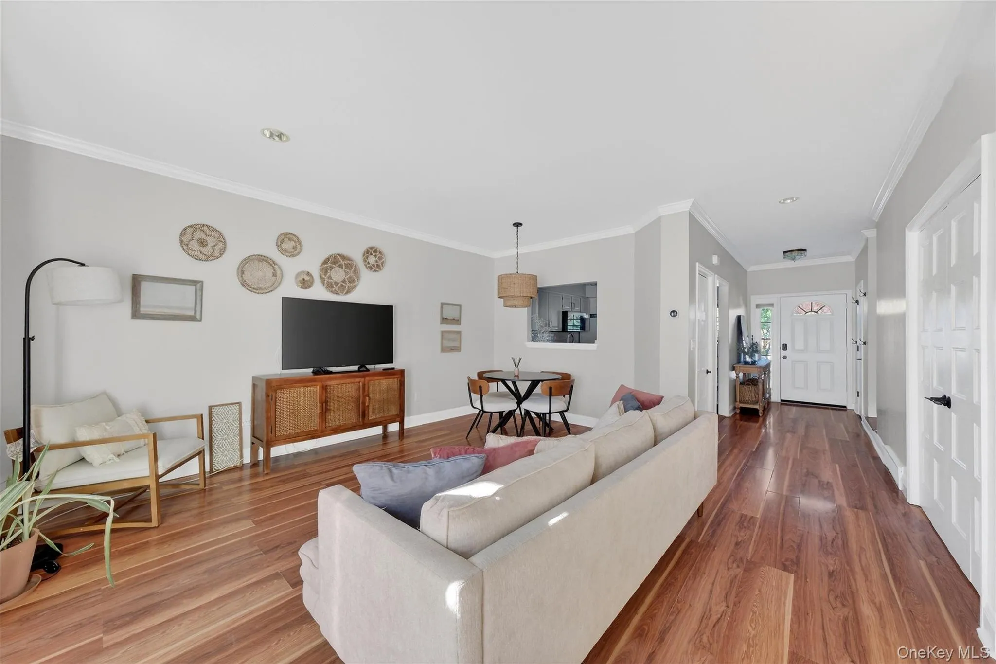 Living room featuring crown molding and wood finished floors Living room featuring crown molding and wood finished floors