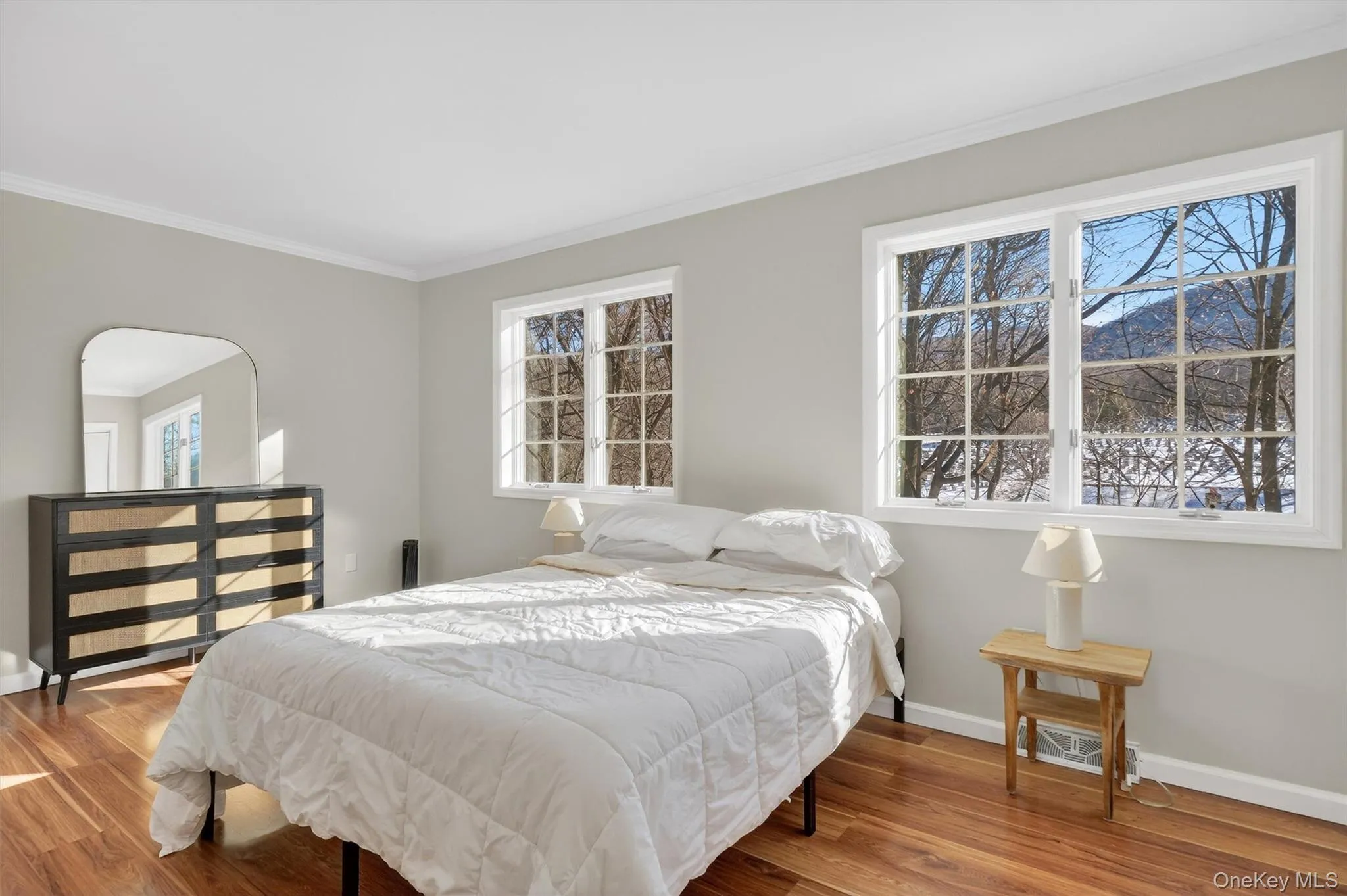 Bedroom featuring ornamental molding and wood finished floors Bedroom featuring ornamental molding and wood finished floors