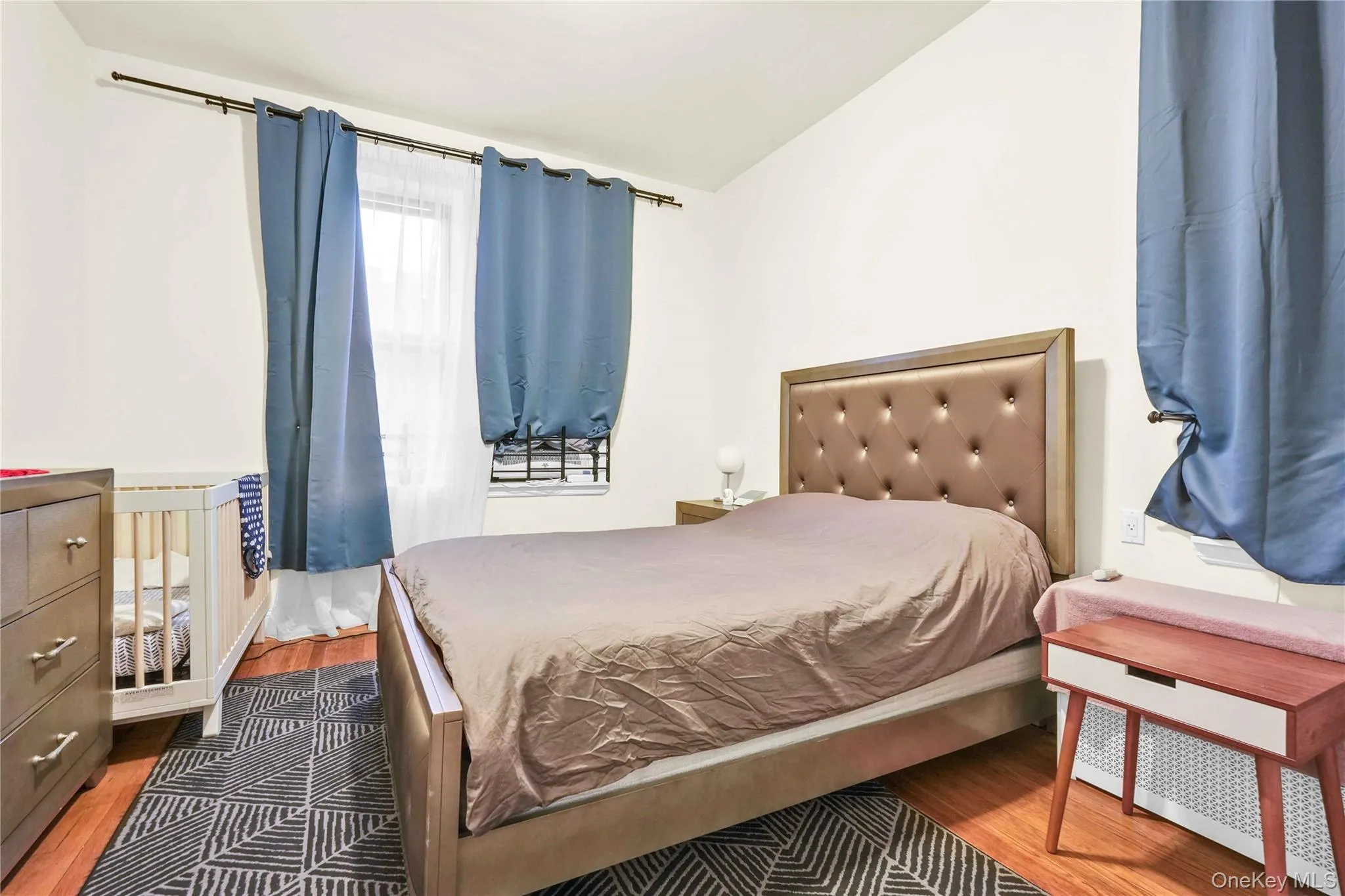 Bedroom featuring wood finished floors Bedroom featuring wood finished floors