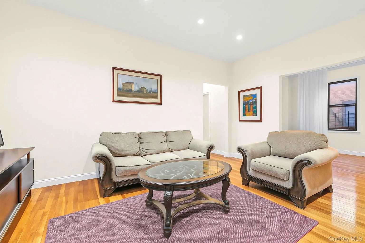 Living area with light wood finished floors and recessed lighting Living area with light wood finished floors and recessed lighting