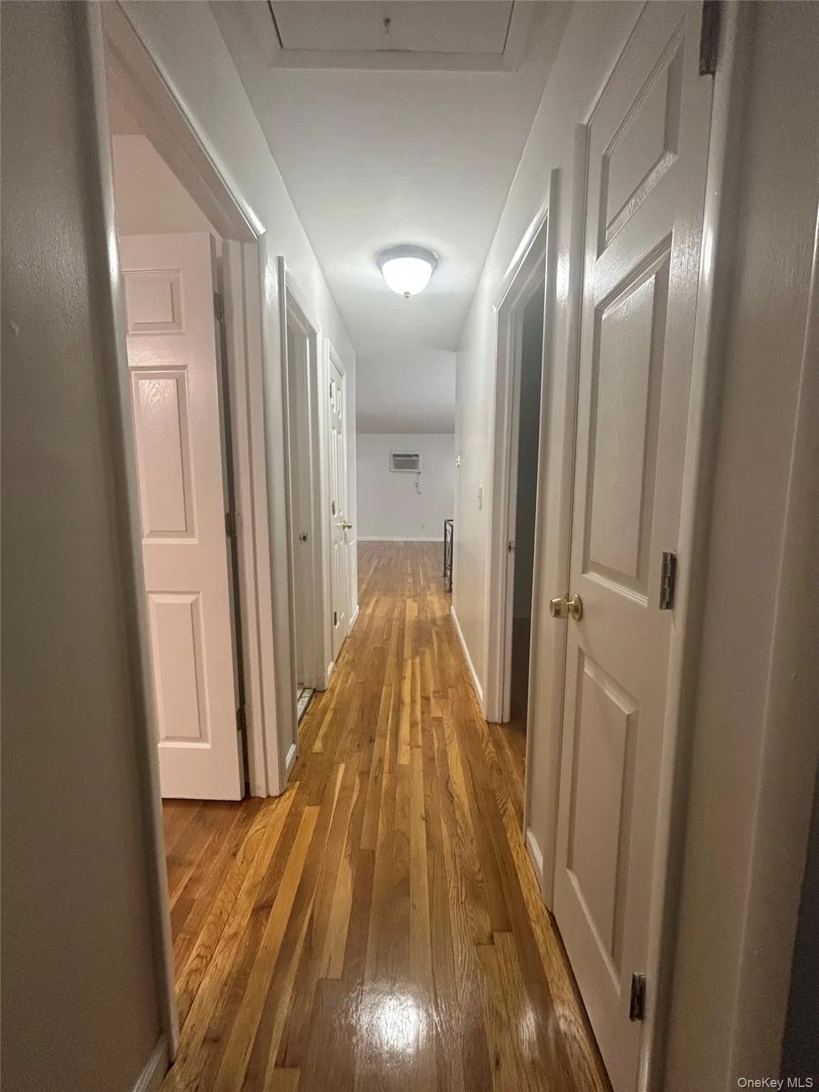 Corridor with light wood-style flooring and baseboards Corridor with light wood-style flooring and baseboards