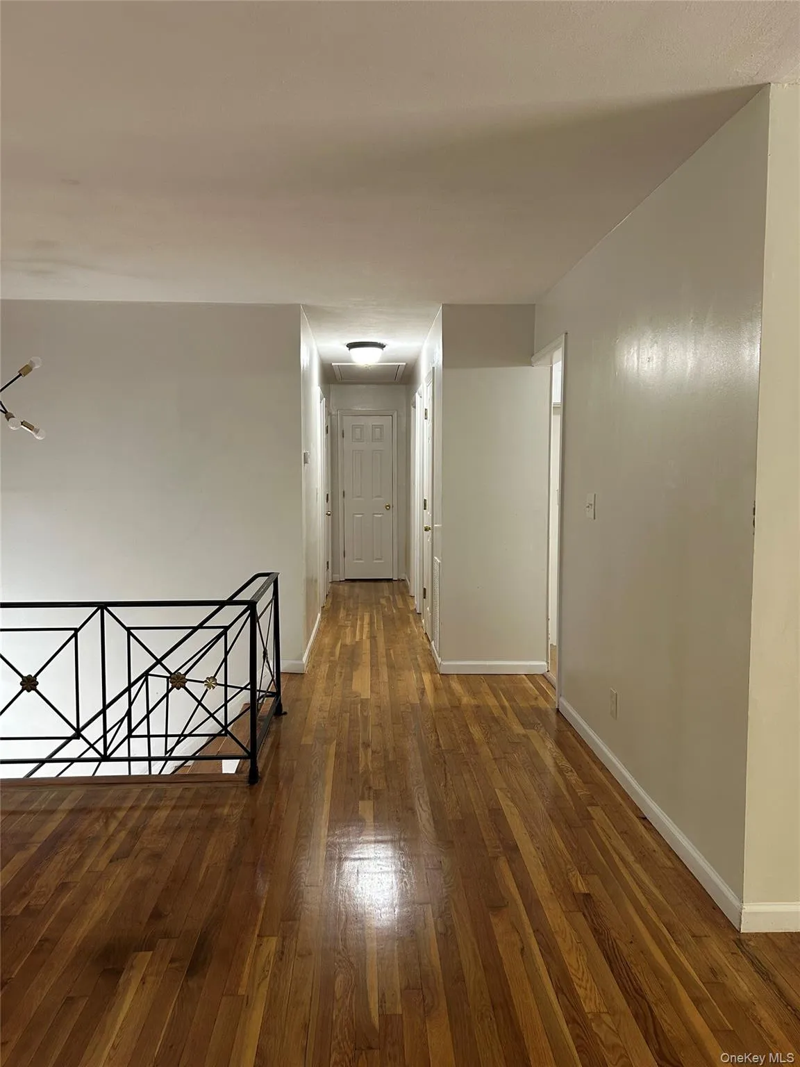 Hall with an upstairs landing and dark wood-type flooring Hall with an upstairs landing and dark wood-type flooring
