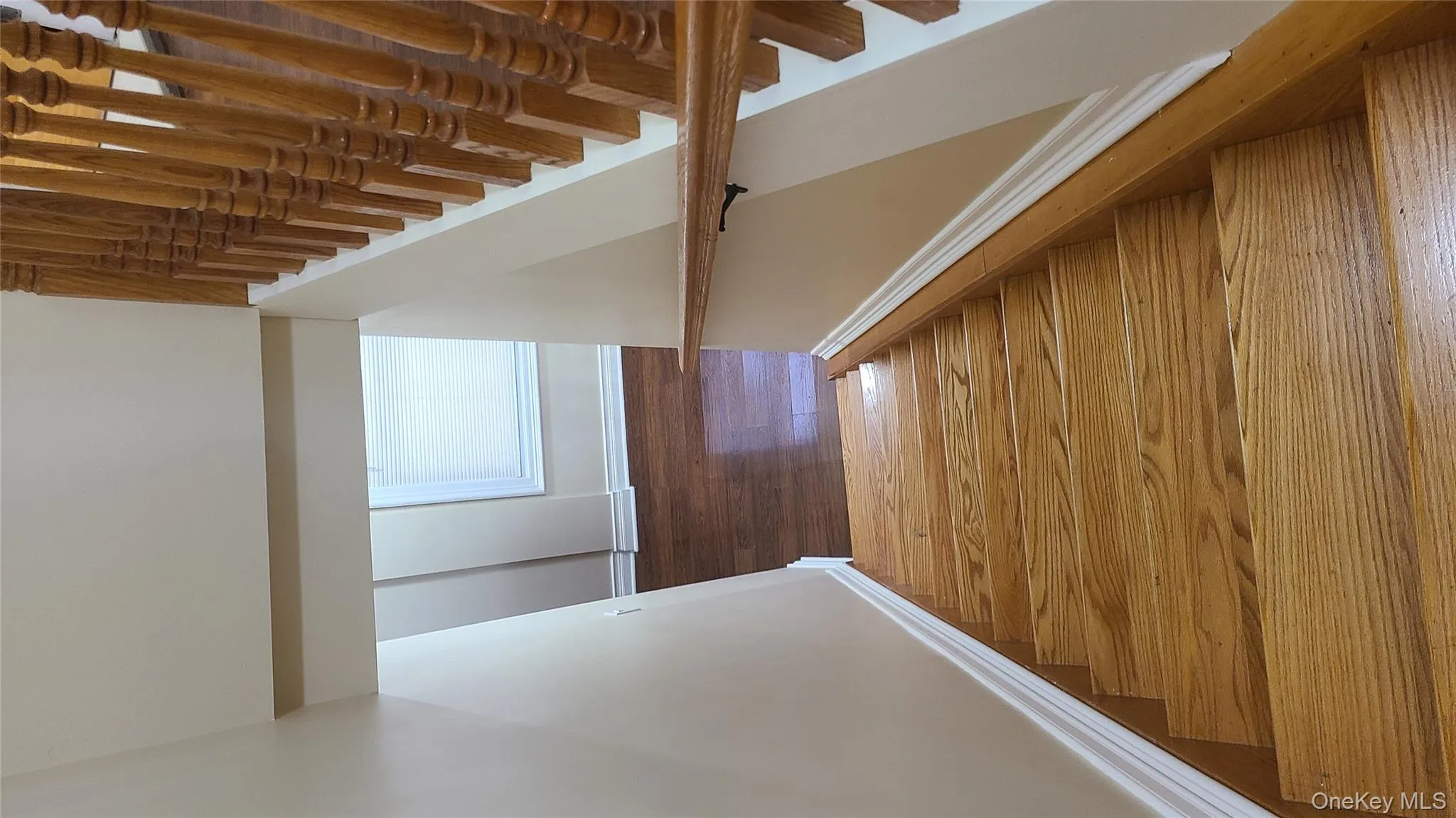 Stairs featuring hardwood / wood-style floors and baseboards Stairs featuring hardwood / wood-style floors and baseboards