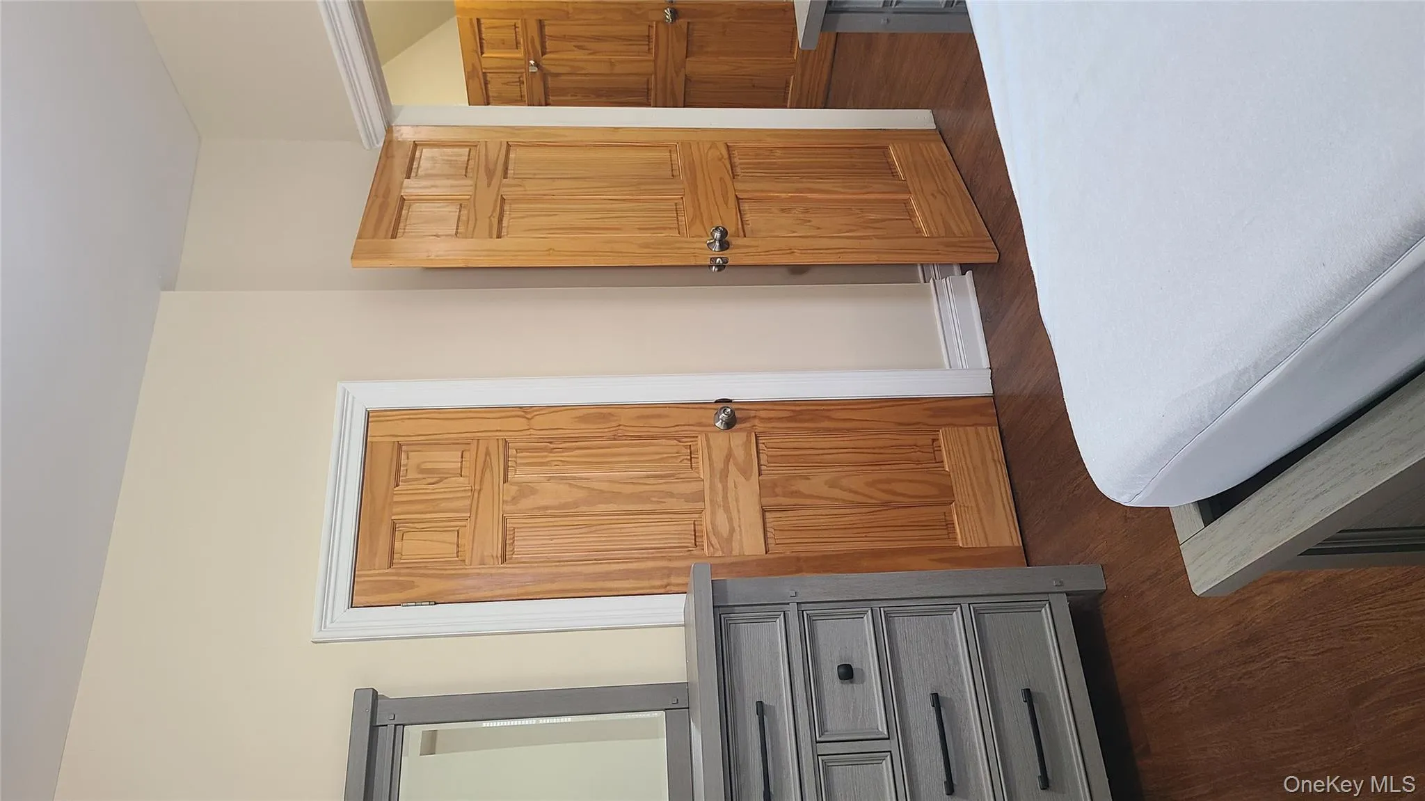Bedroom featuring dark wood finished floors Bedroom featuring dark wood finished floors