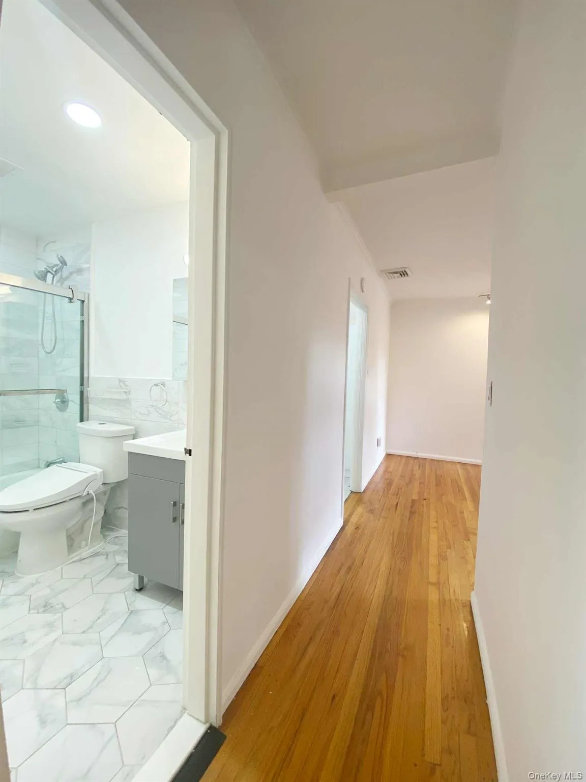 Hall featuring baseboards and recessed lighting Hall featuring baseboards and recessed lighting