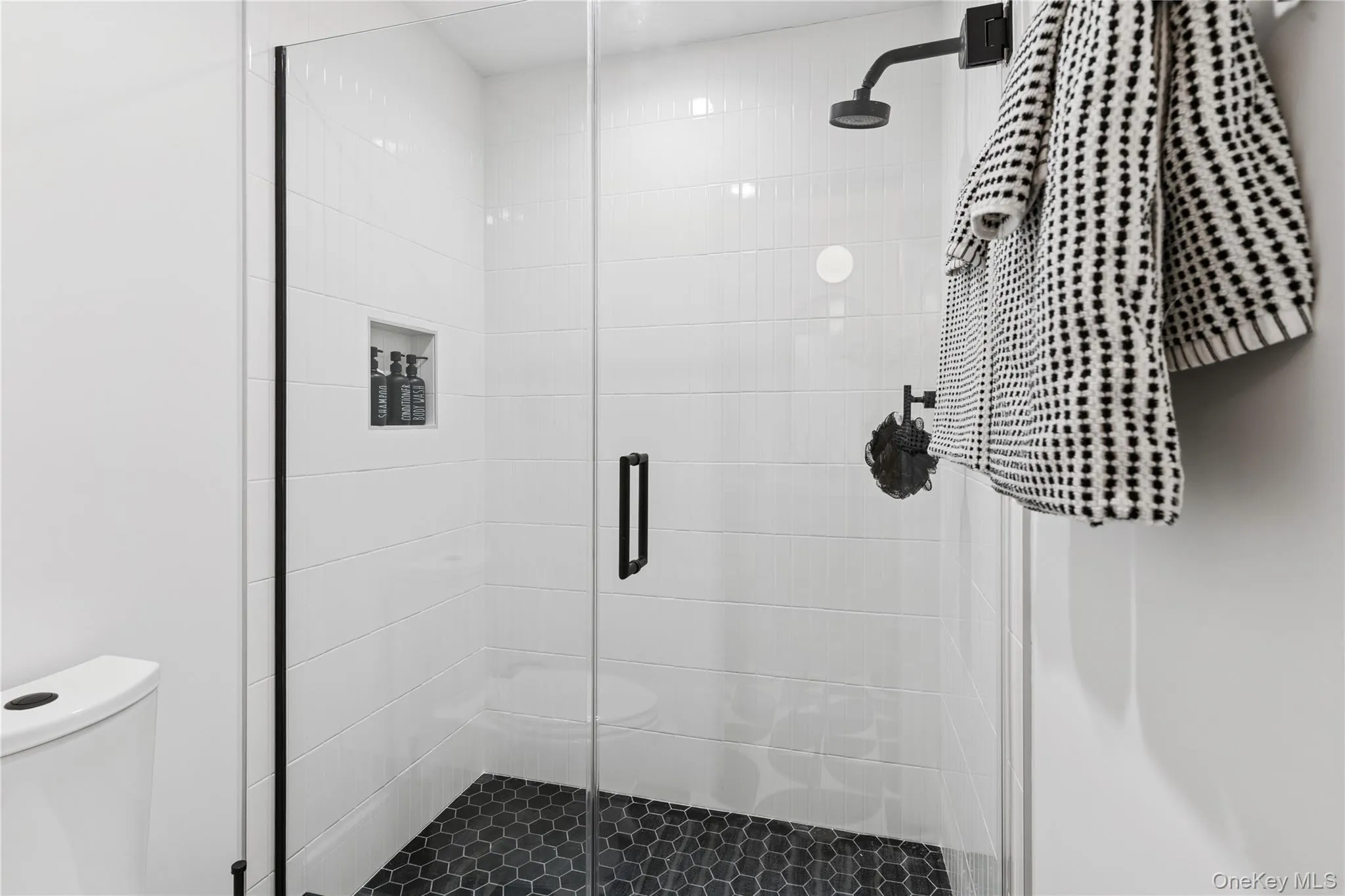 Full guest bathroom featuring a stall shower and toilet Full guest bathroom featuring a stall shower and toilet