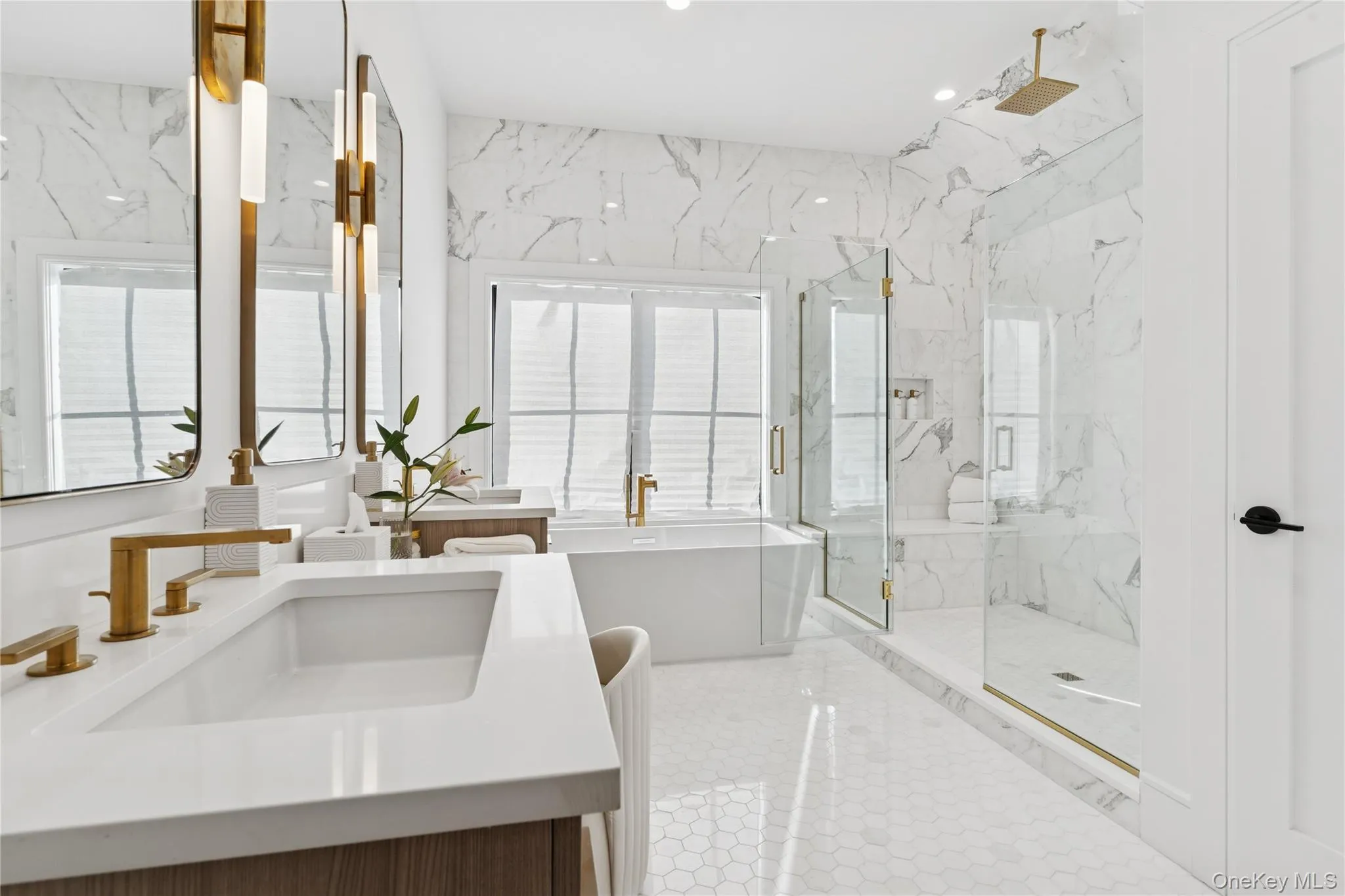 Primary Bathroom featuring a freestanding bath, a marble finish shower, vanity, recessed lighting, and light tile patterned floors Primary Bathroom featuring a freestanding bath, a marble finish shower, vanity, recessed lighting, and light tile patterned floors