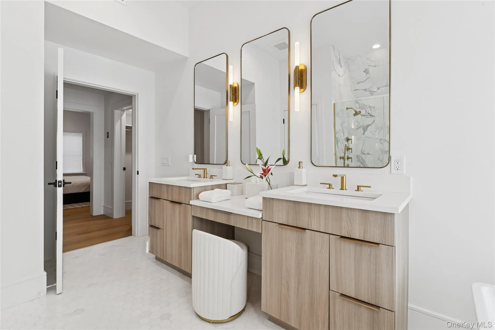 primary en-suite Bathroom featuring double vanity, a marble finish shower, and ensuite bathroom primary en-suite Bathroom featuring double vanity, a marble finish shower, and ensuite bathroom