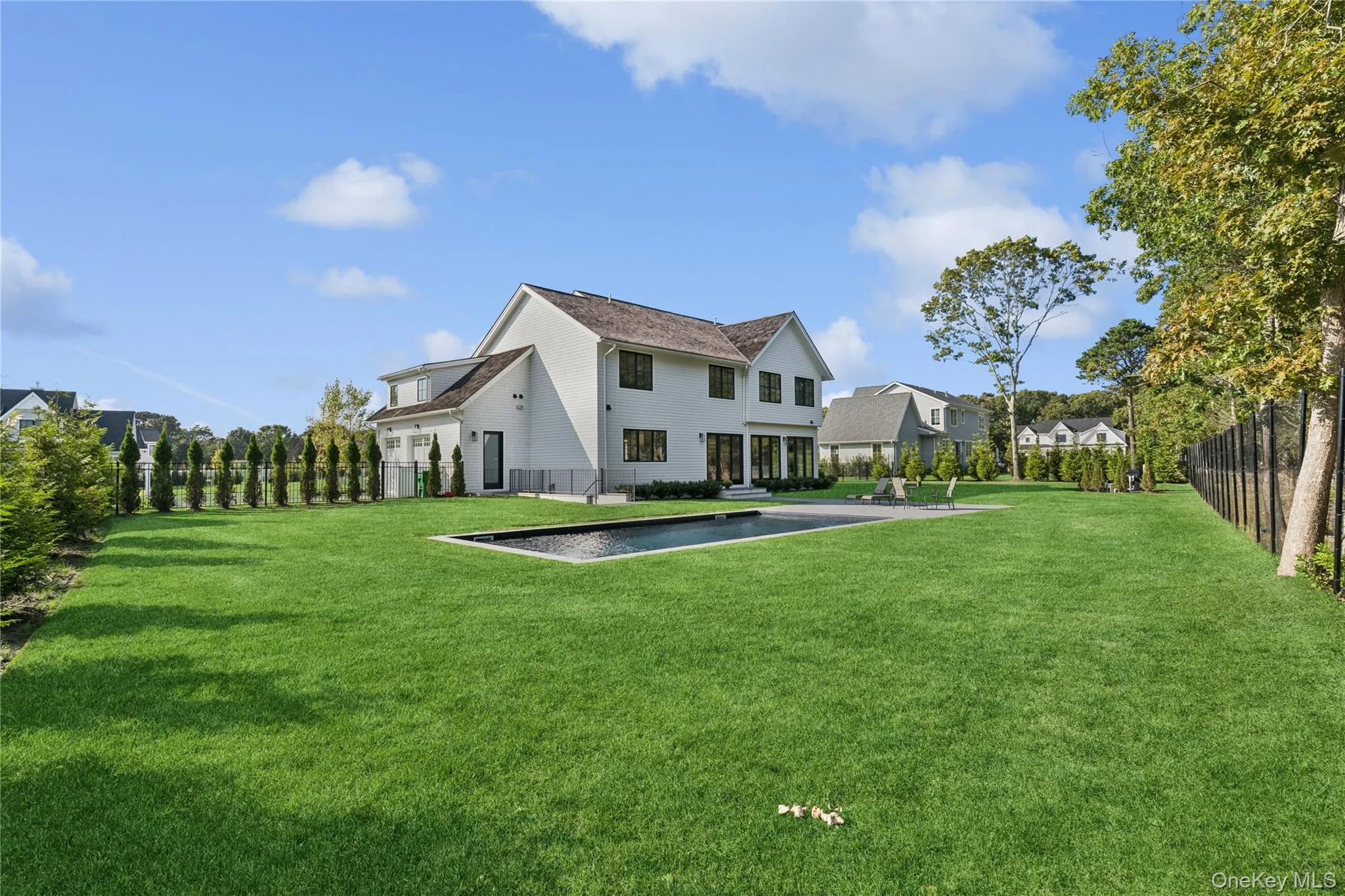 Back of property with a fenced backyard and pool Back of property with a fenced backyard and pool