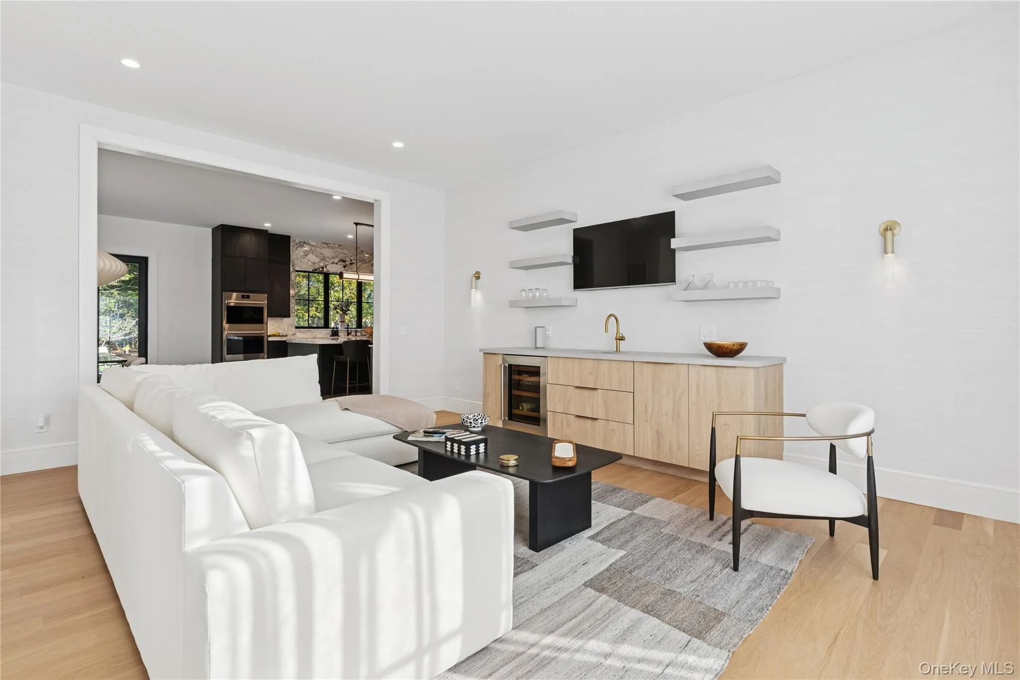 Living area featuring light wood-style floors, beverage cooler, and recessed lighting Living area featuring light wood-style floors, beverage cooler, and recessed lighting