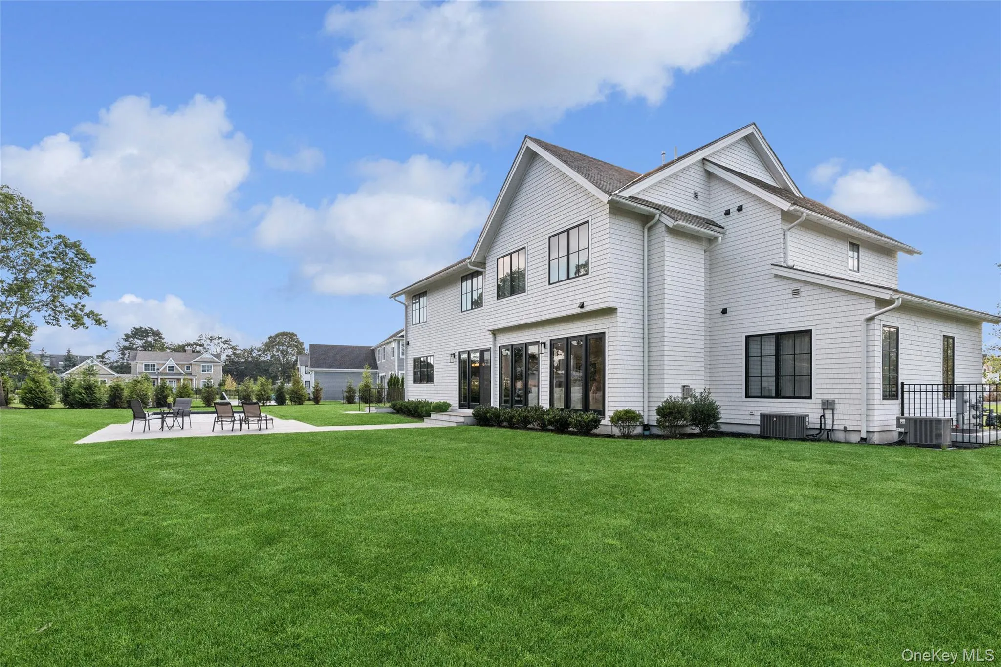 Rear view of property featuring a patio area, pool and a yard Rear view of property featuring a patio area, pool and a yard