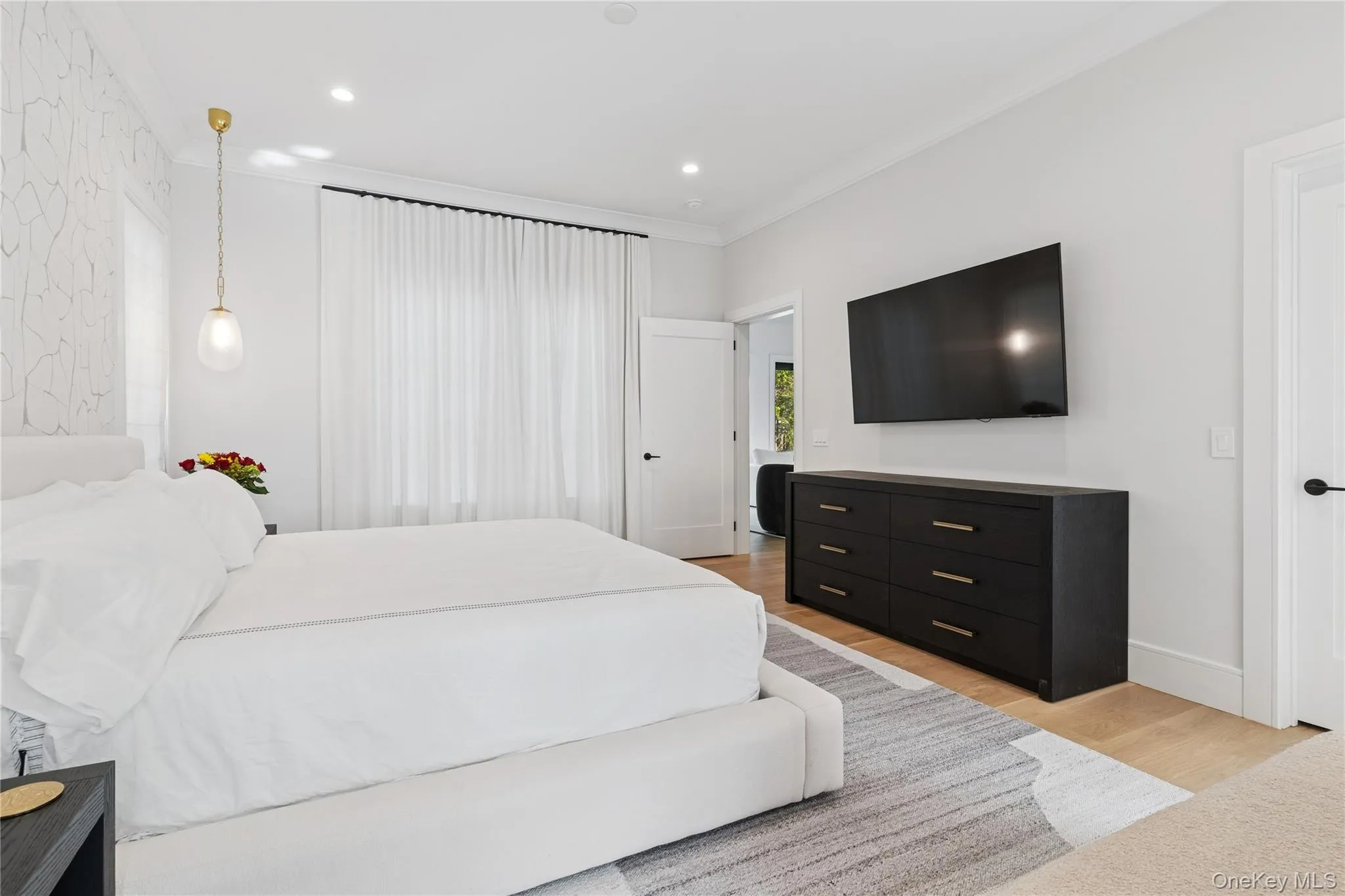 primary Bedroom with light wood-type flooring, ornamental molding, and recessed lighting primary Bedroom with light wood-type flooring, ornamental molding, and recessed lighting