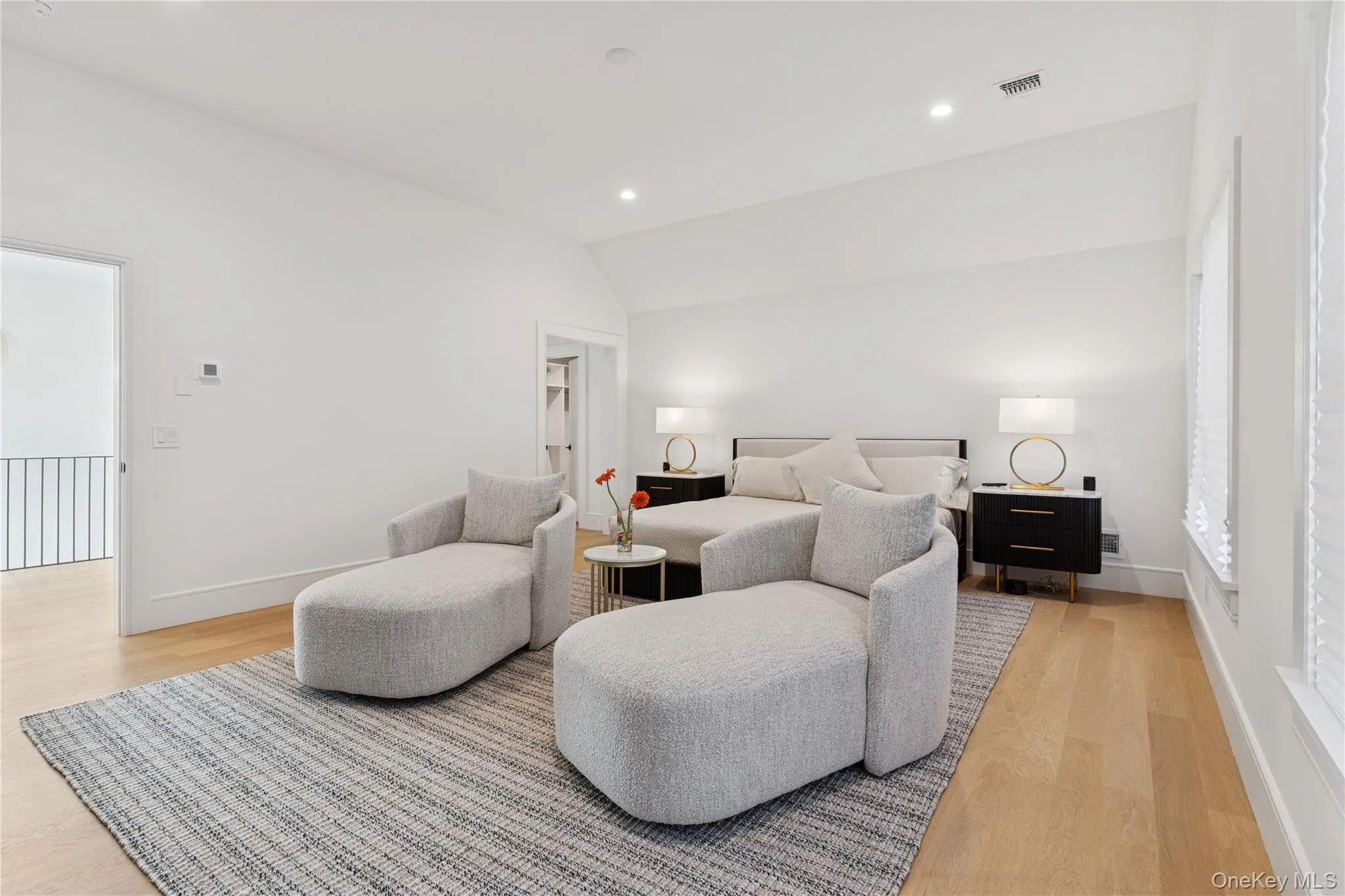 Bedroom with lofted ceiling, light wood-style flooring, and recessed lighting Bedroom with lofted ceiling, light wood-style flooring, and recessed lighting