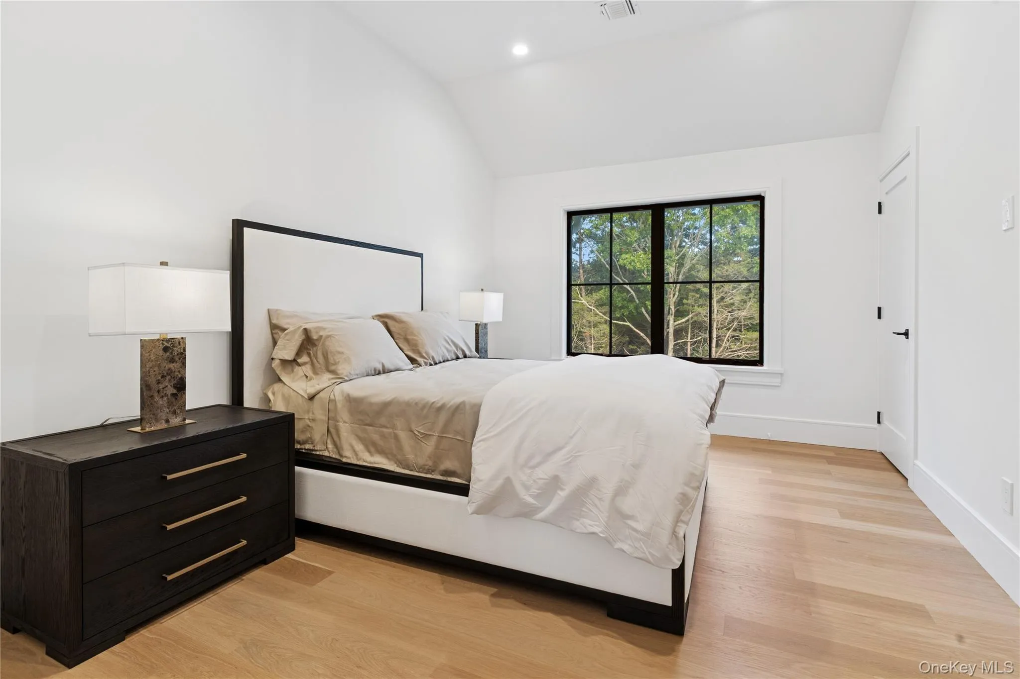 Bedroom featuring vaulted ceiling, light wood-style flooring, and recessed lighting Bedroom featuring vaulted ceiling, light wood-style flooring, and recessed lighting