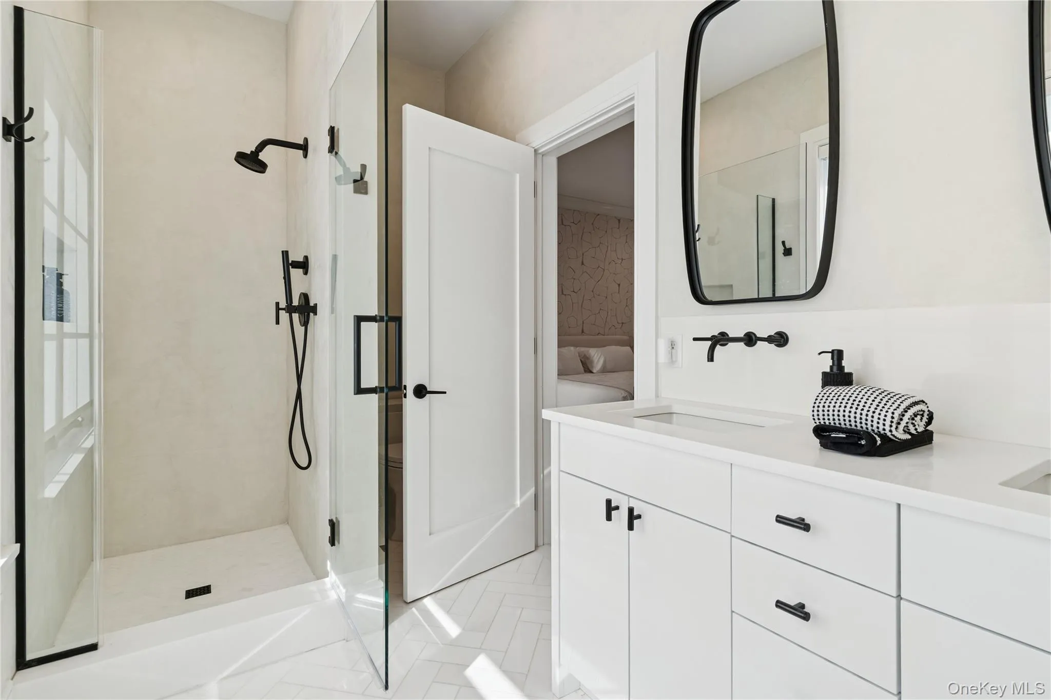 Full bath featuring double vanity, walk in shower, and light tile patterned flooring Full bath featuring double vanity, walk in shower, and light tile patterned flooring