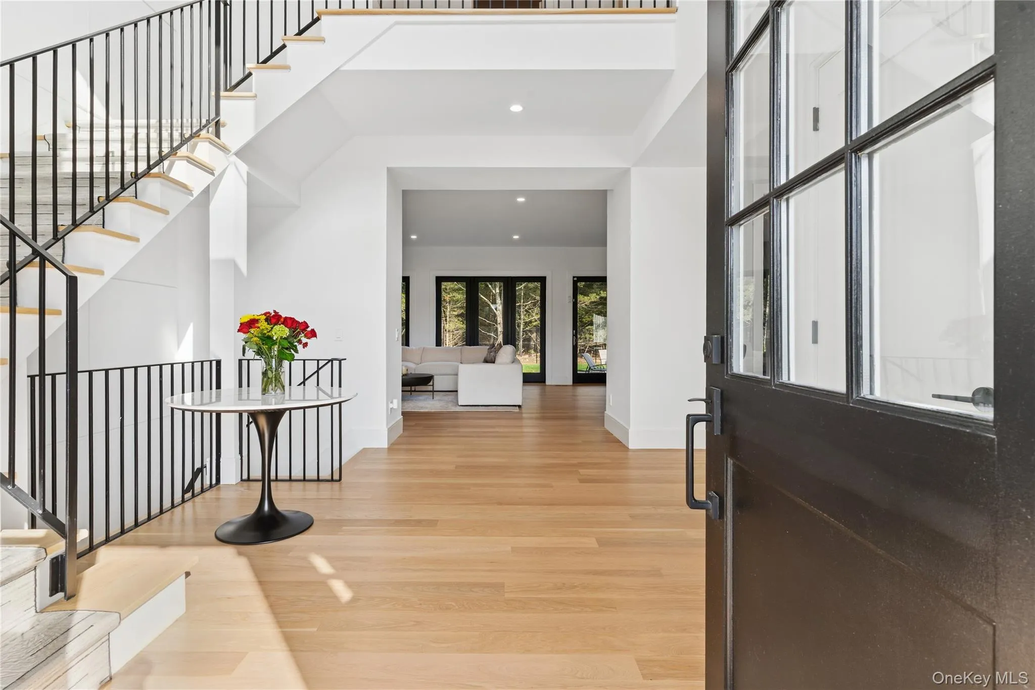 Foyer with recessed lighting, light wood-style floors, and stairway Foyer with recessed lighting, light wood-style floors, and stairway