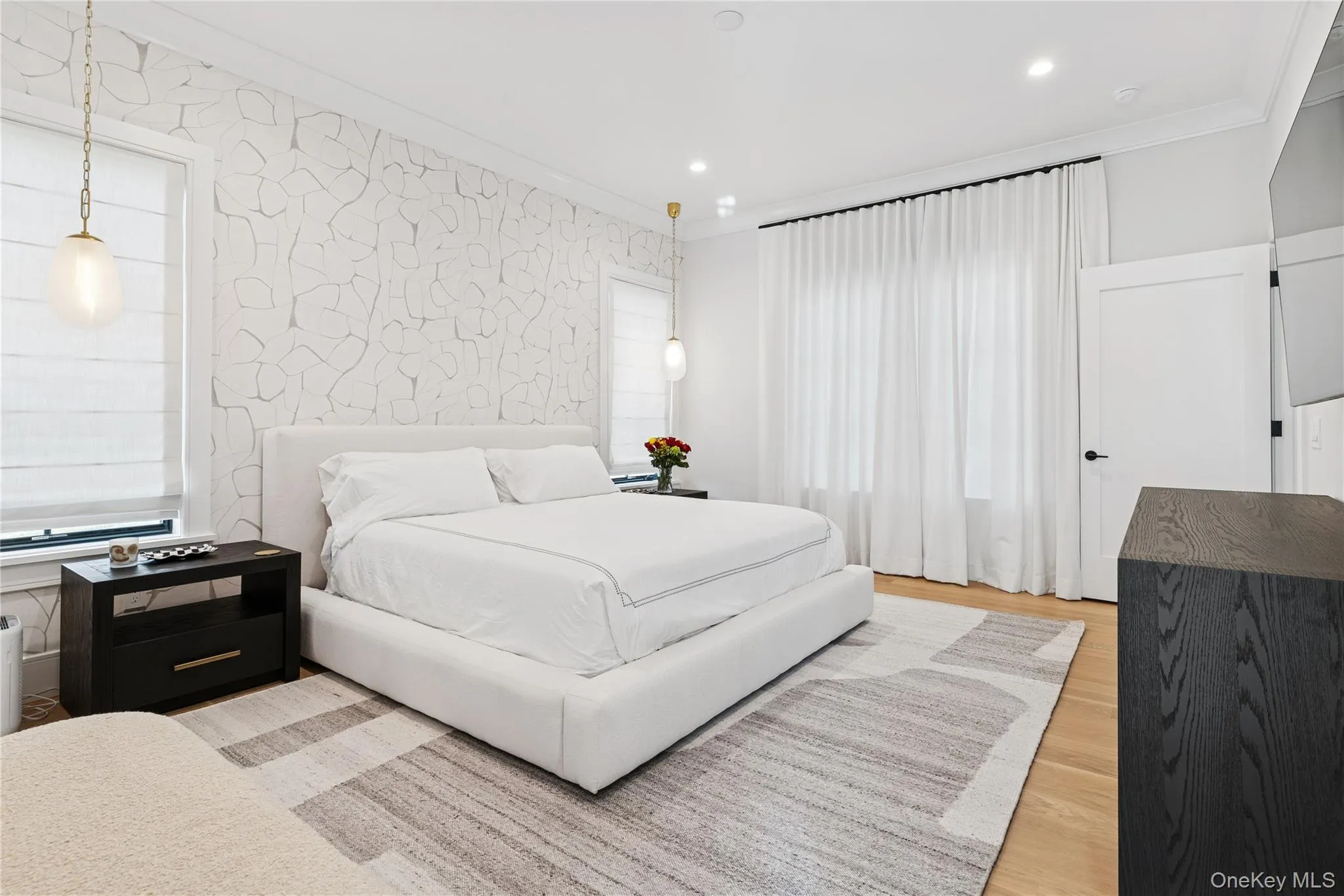 Bedroom with wood finished floors, crown molding, wallpapered walls, and recessed lighting Bedroom with wood finished floors, crown molding, wallpapered walls, and recessed lighting