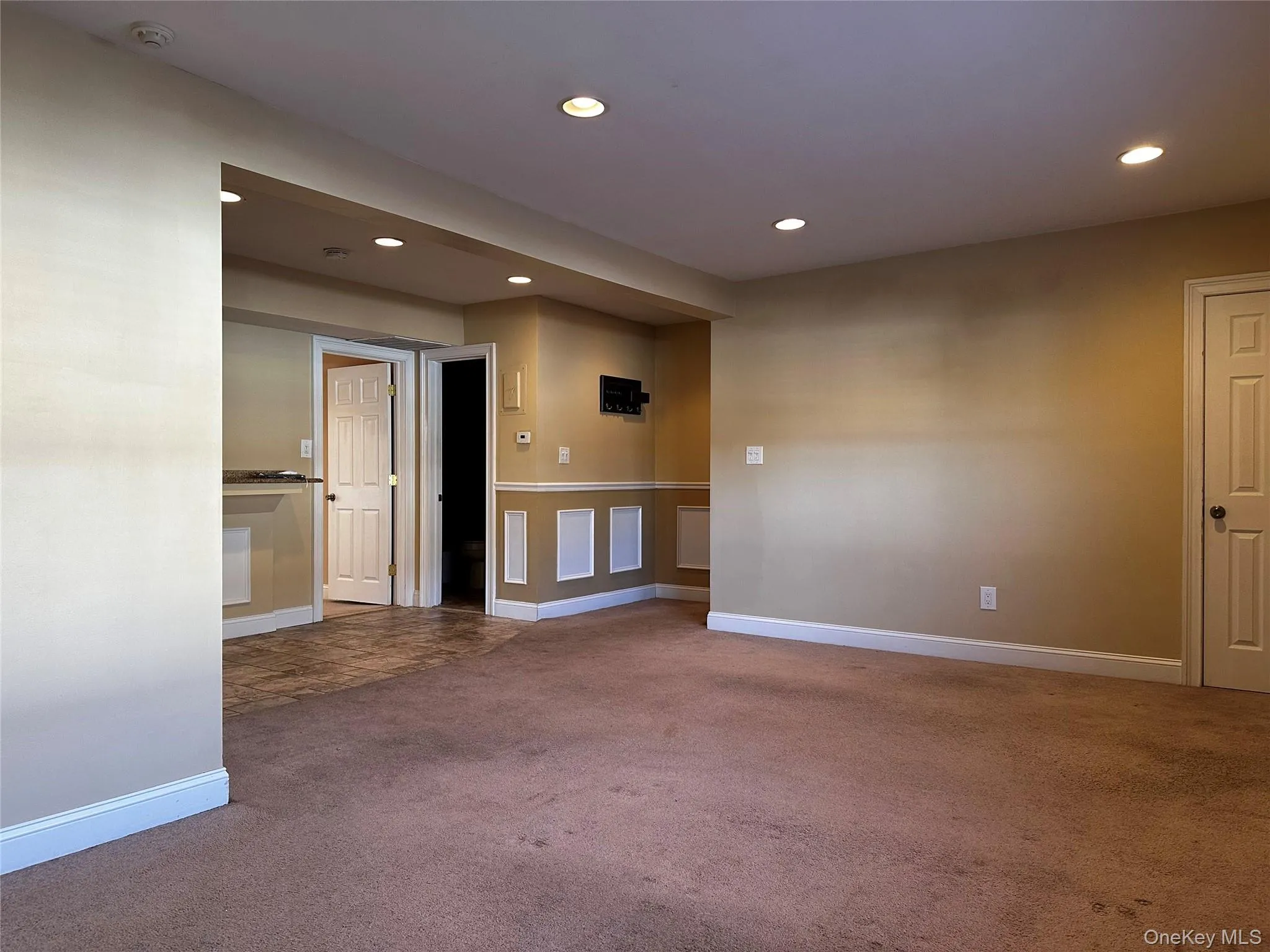 Carpeted living room with recessed lighting Carpeted living room with recessed lighting