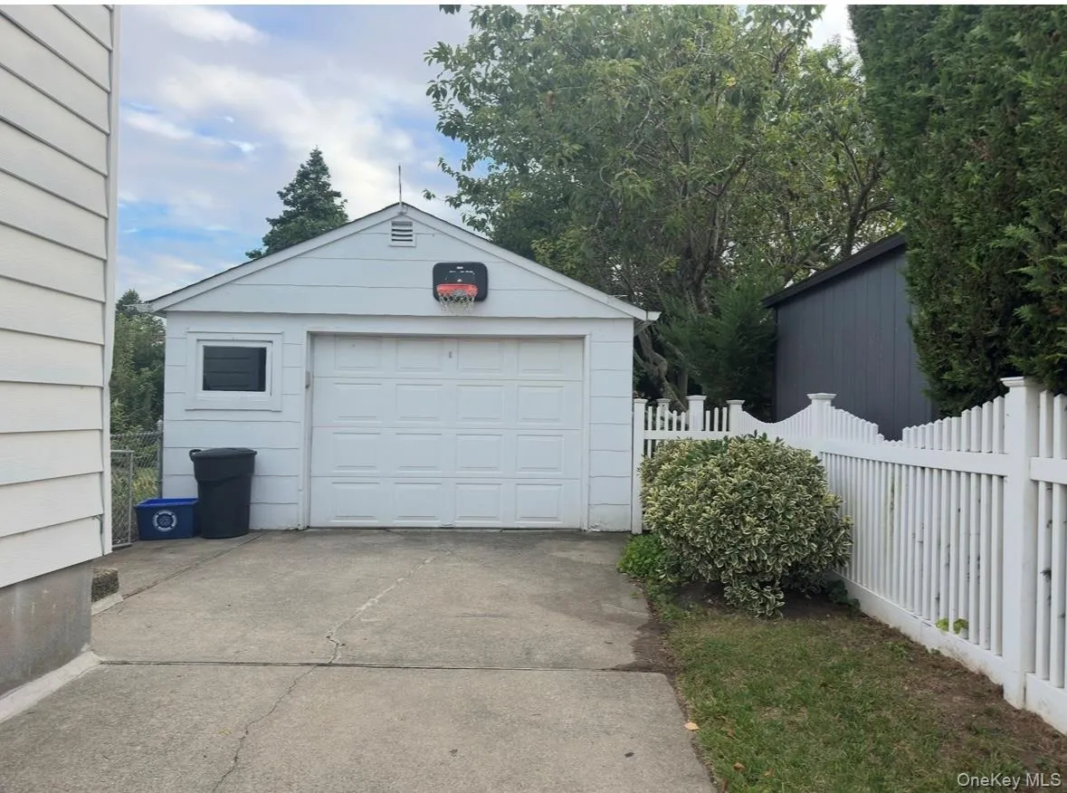 Detached garage featuring concrete driveway Detached garage featuring concrete driveway