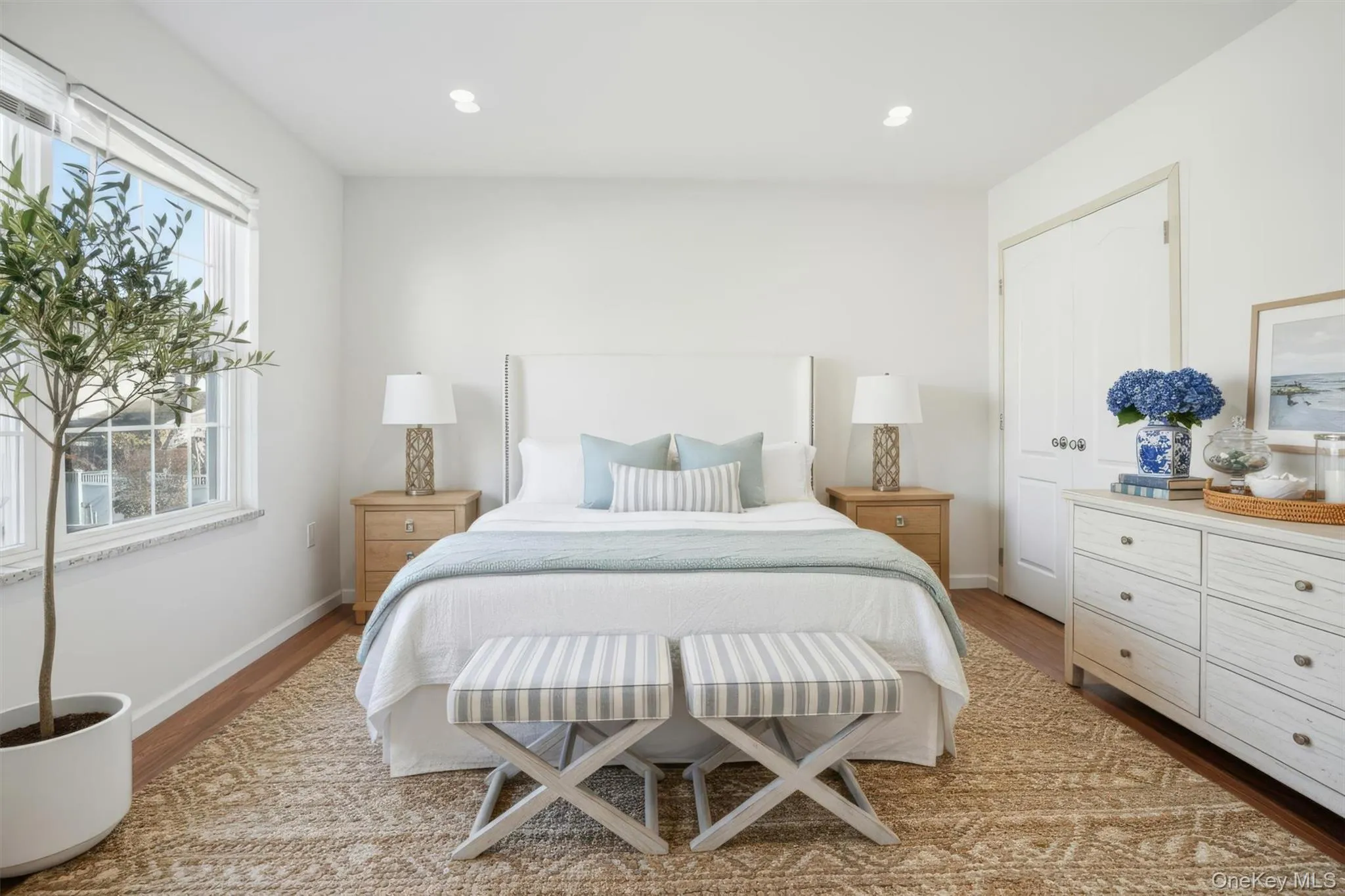 Bedroom featuring light wood-type flooring and recessed lighting Bedroom featuring light wood-type flooring and recessed lighting