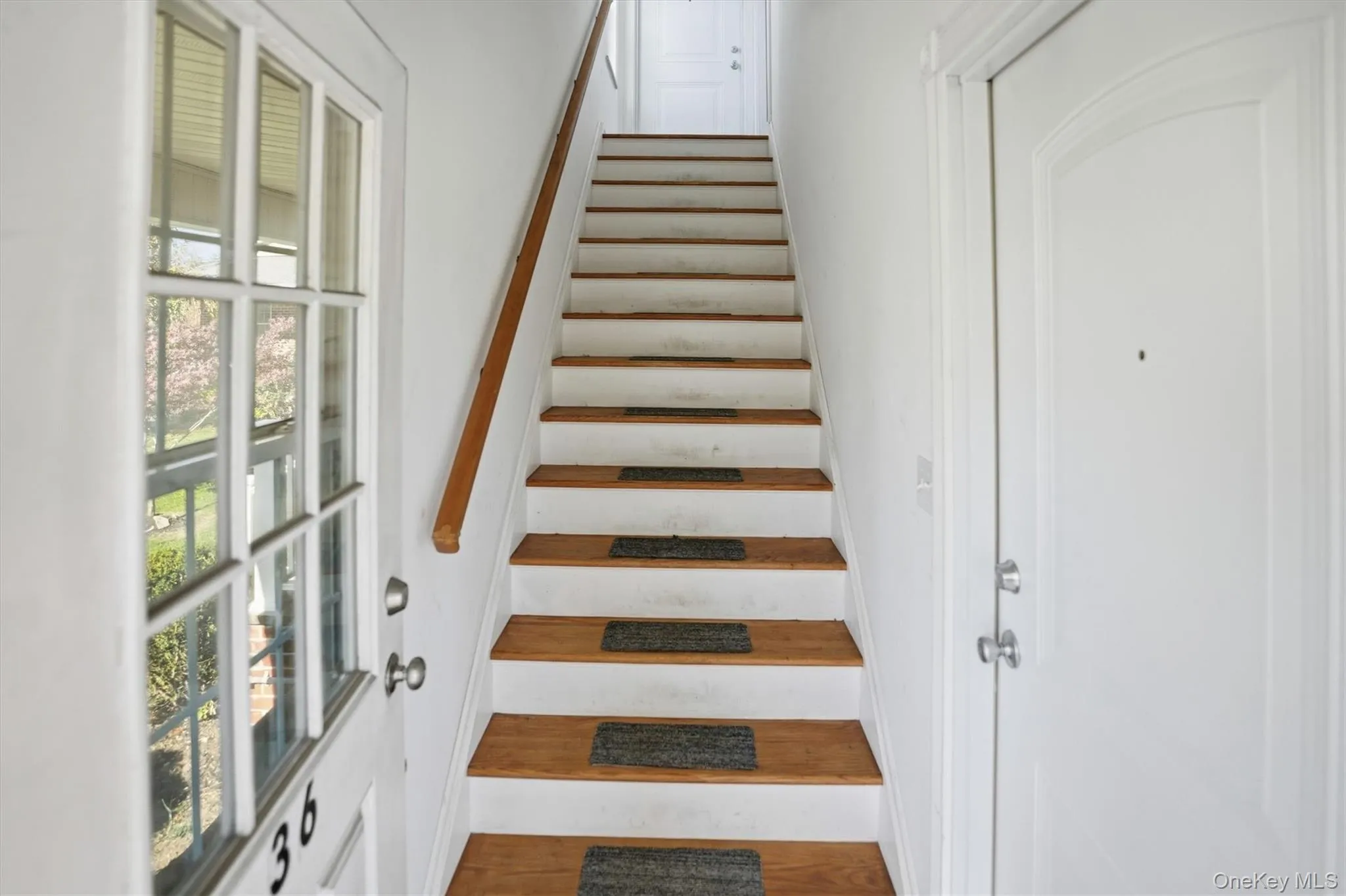 Stairs with wood finished floors and baseboards Stairs with wood finished floors and baseboards