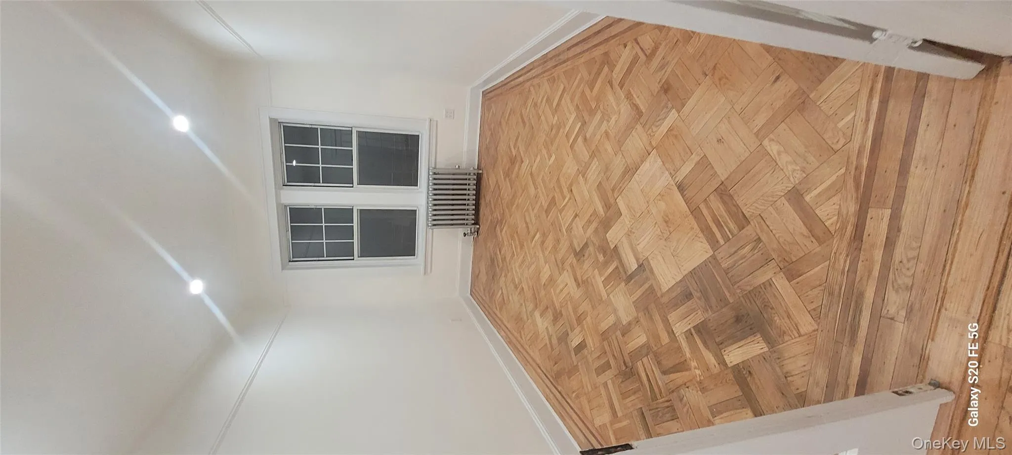 Spare room featuring radiator heating unit and recessed lighting Spare room featuring radiator heating unit and recessed lighting