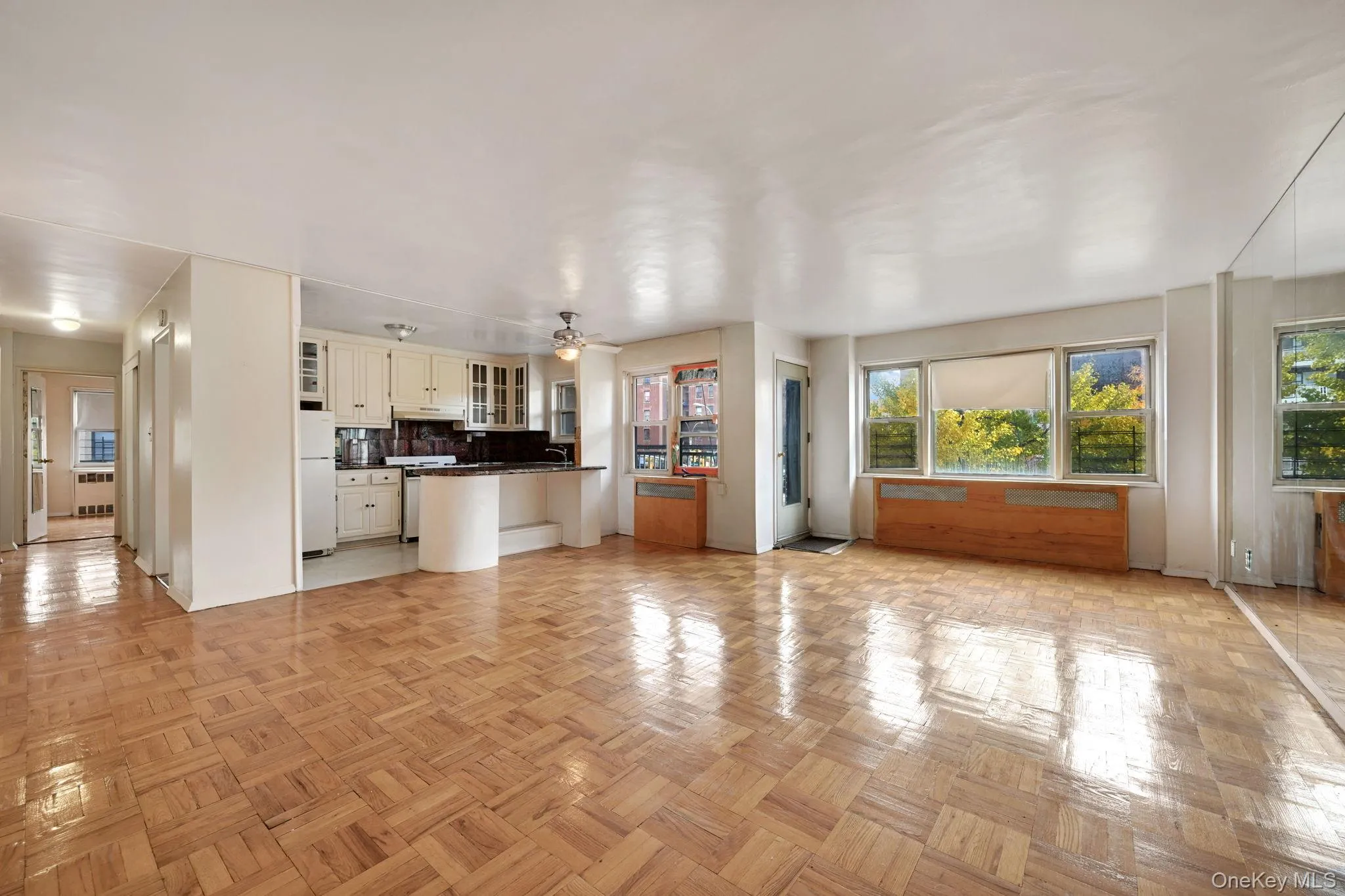 Unfurnished living room with a ceiling fan and radiator Unfurnished living room with a ceiling fan and radiator