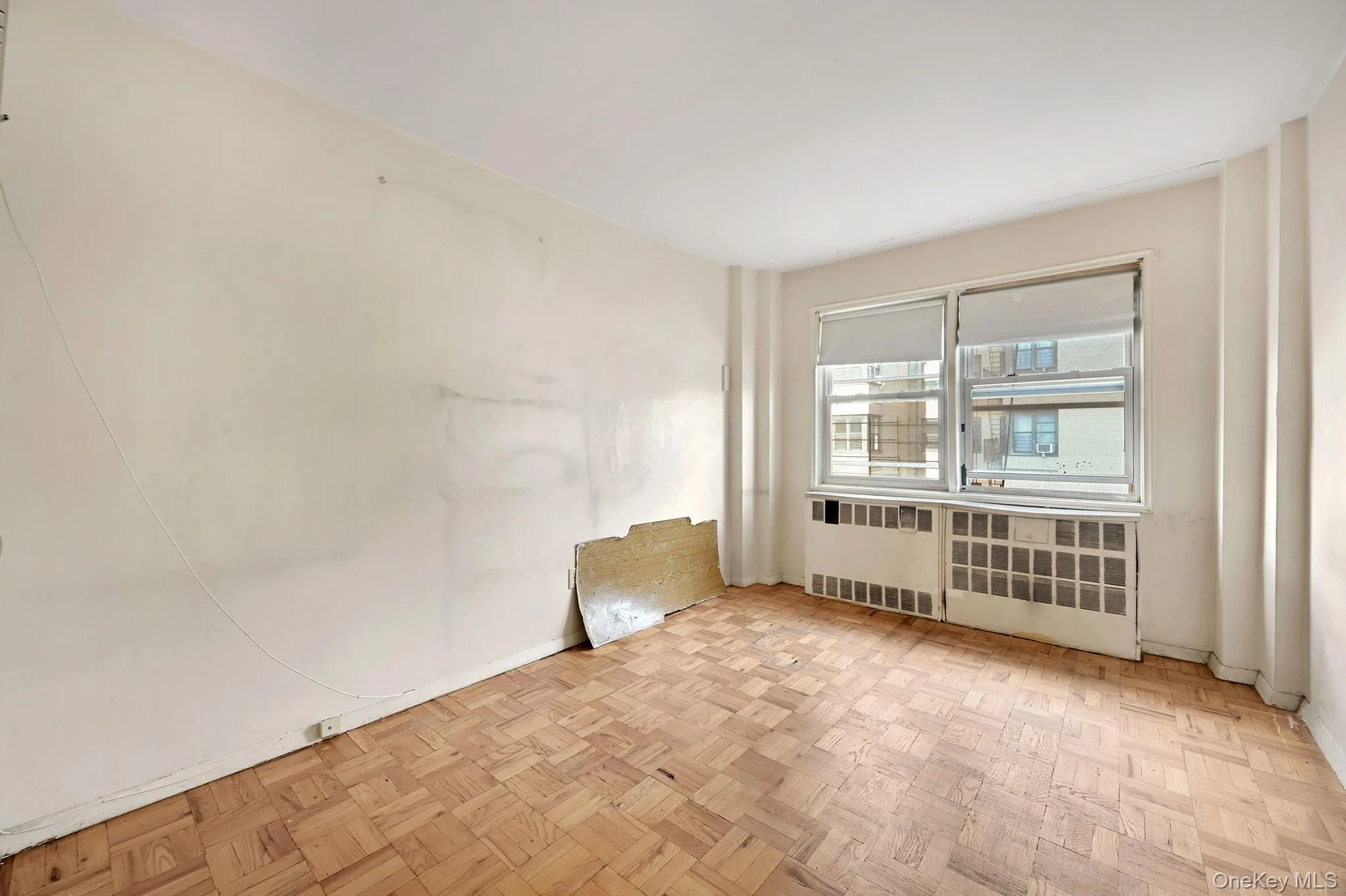 Spare room with baseboards and radiator Spare room with baseboards and radiator