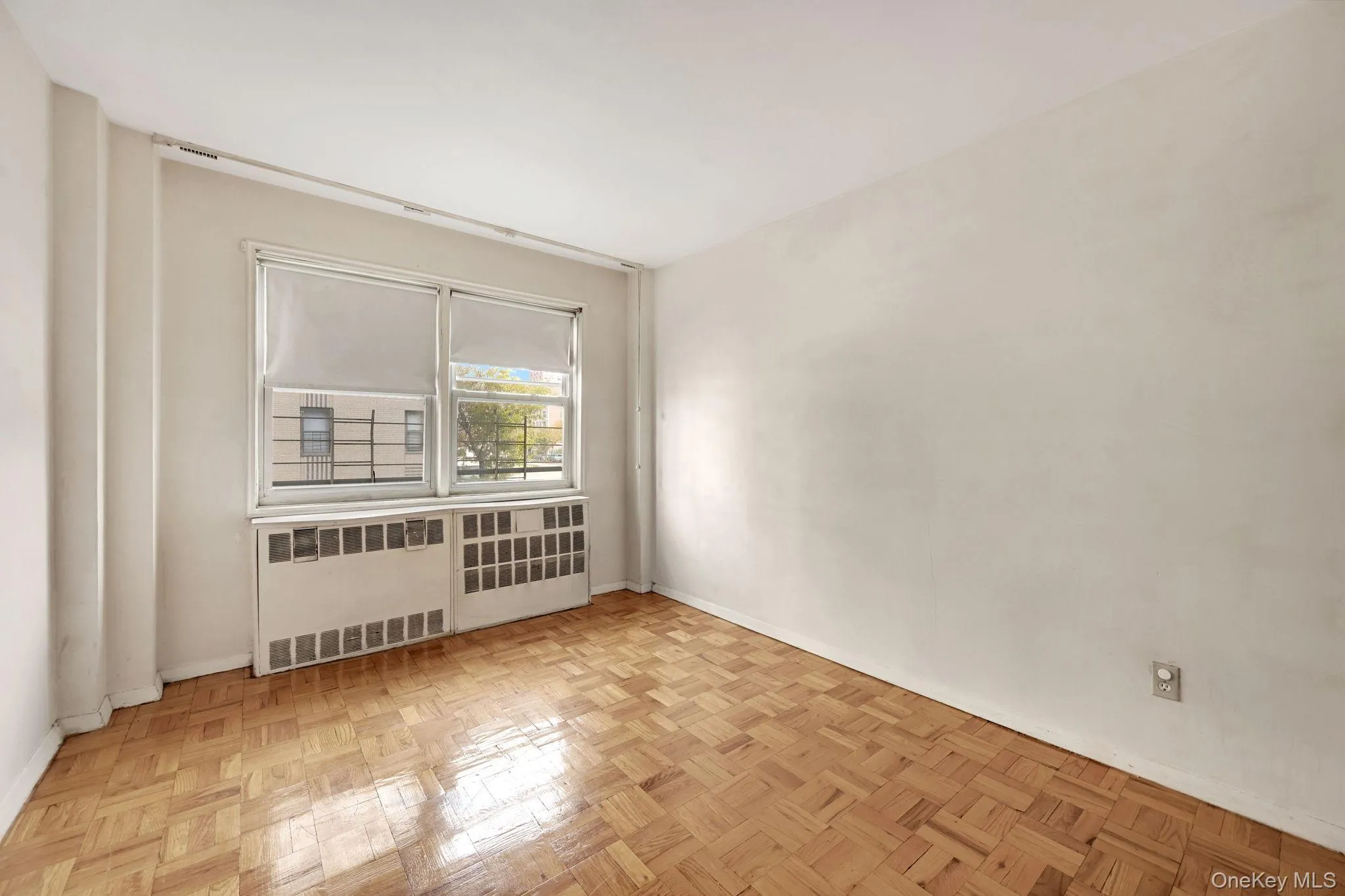Unfurnished room featuring baseboards and radiator Unfurnished room featuring baseboards and radiator