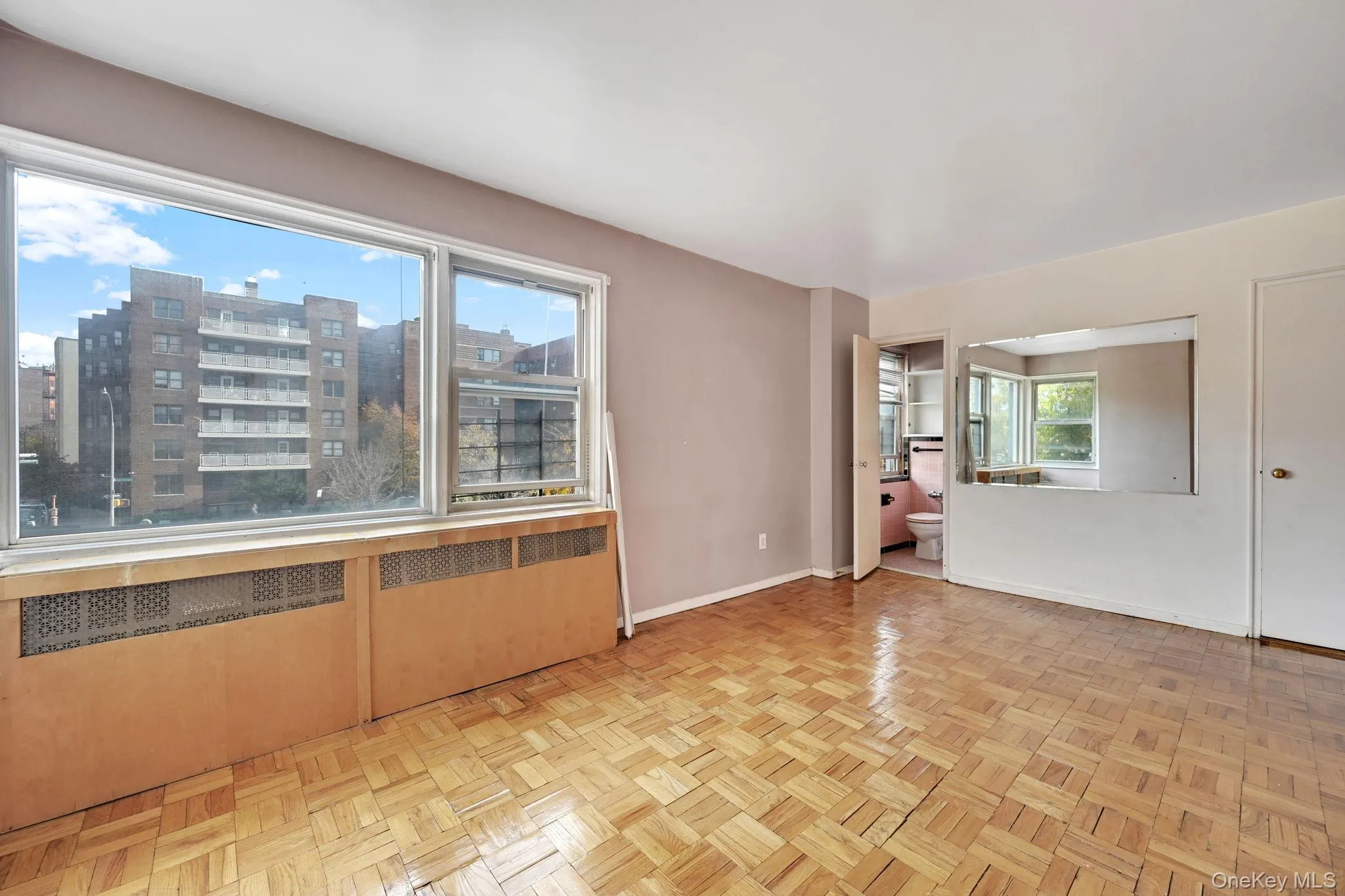 Spare room featuring radiator heating unit and baseboards Spare room featuring radiator heating unit and baseboards