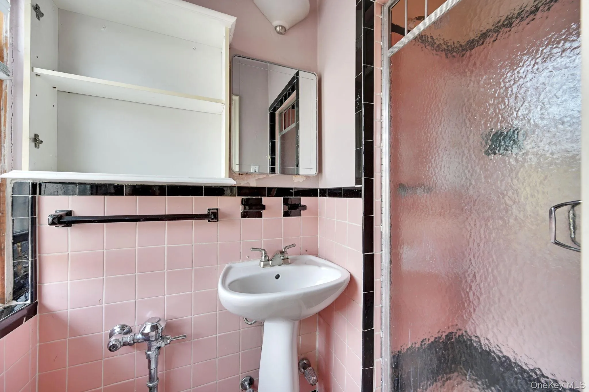 Bathroom featuring tile walls and a shower stall Bathroom featuring tile walls and a shower stall
