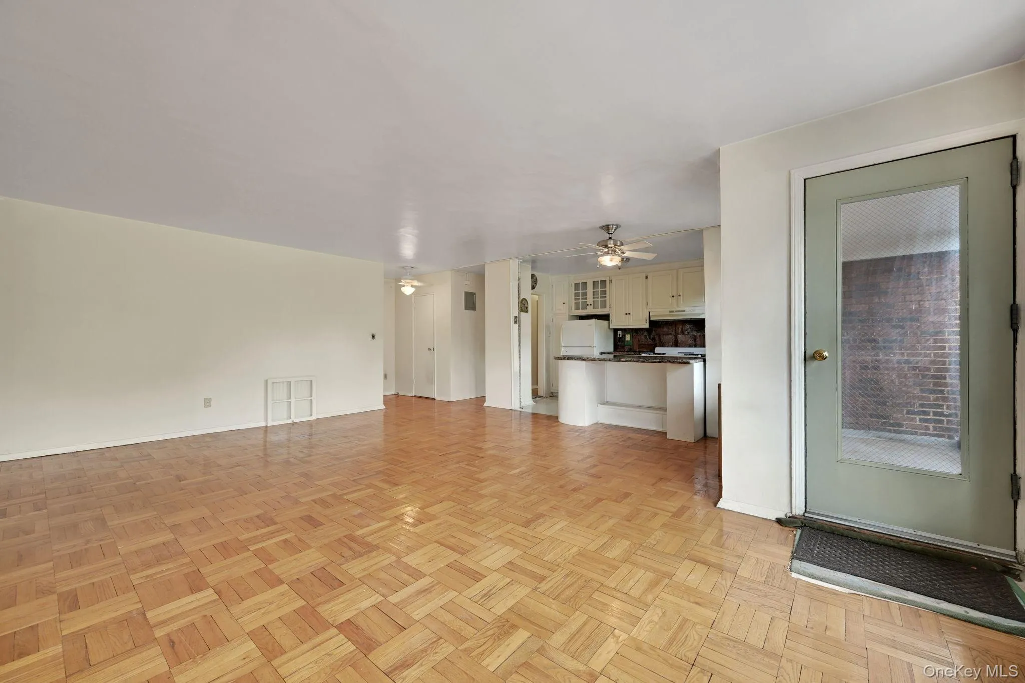 Unfurnished living room with baseboards and a ceiling fan Unfurnished living room with baseboards and a ceiling fan