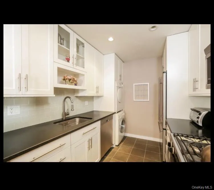 Glass insert cabinets and stacked washer and dryer Glass insert cabinets and stacked washer and dryer