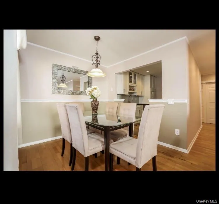 Dining area off kitchen featuring crown molding Dining area off kitchen featuring crown molding