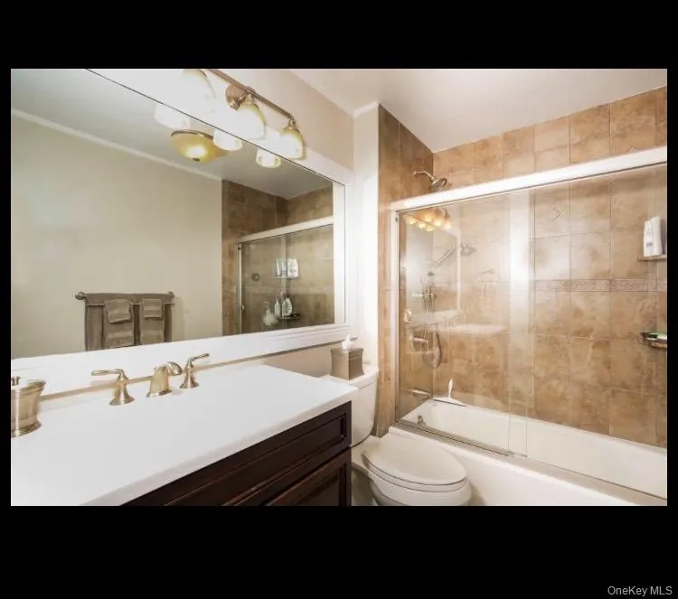 Full bathroom featuring combined bath / shower with glass door, vanity Full bathroom featuring combined bath / shower with glass door, vanity