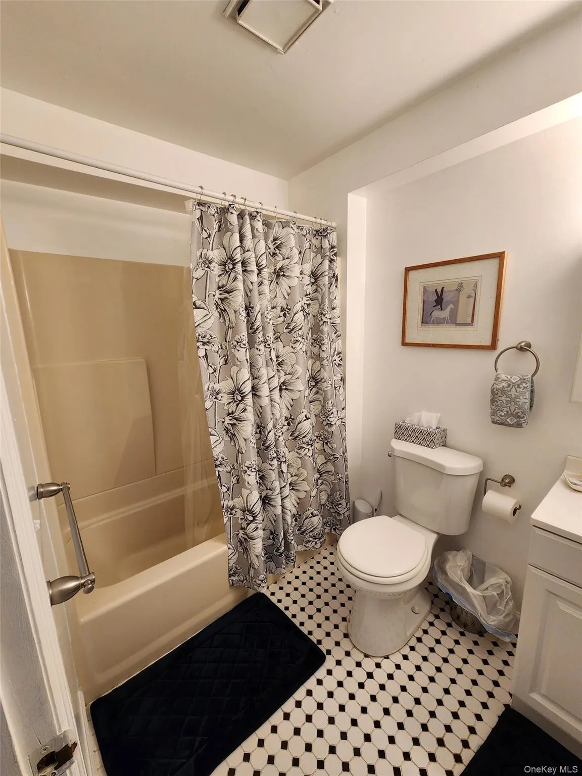 Bathroom with shower / bath combination with curtain, vanity, and tile patterned flooring Bathroom with shower / bath combination with curtain, vanity, and tile patterned flooring