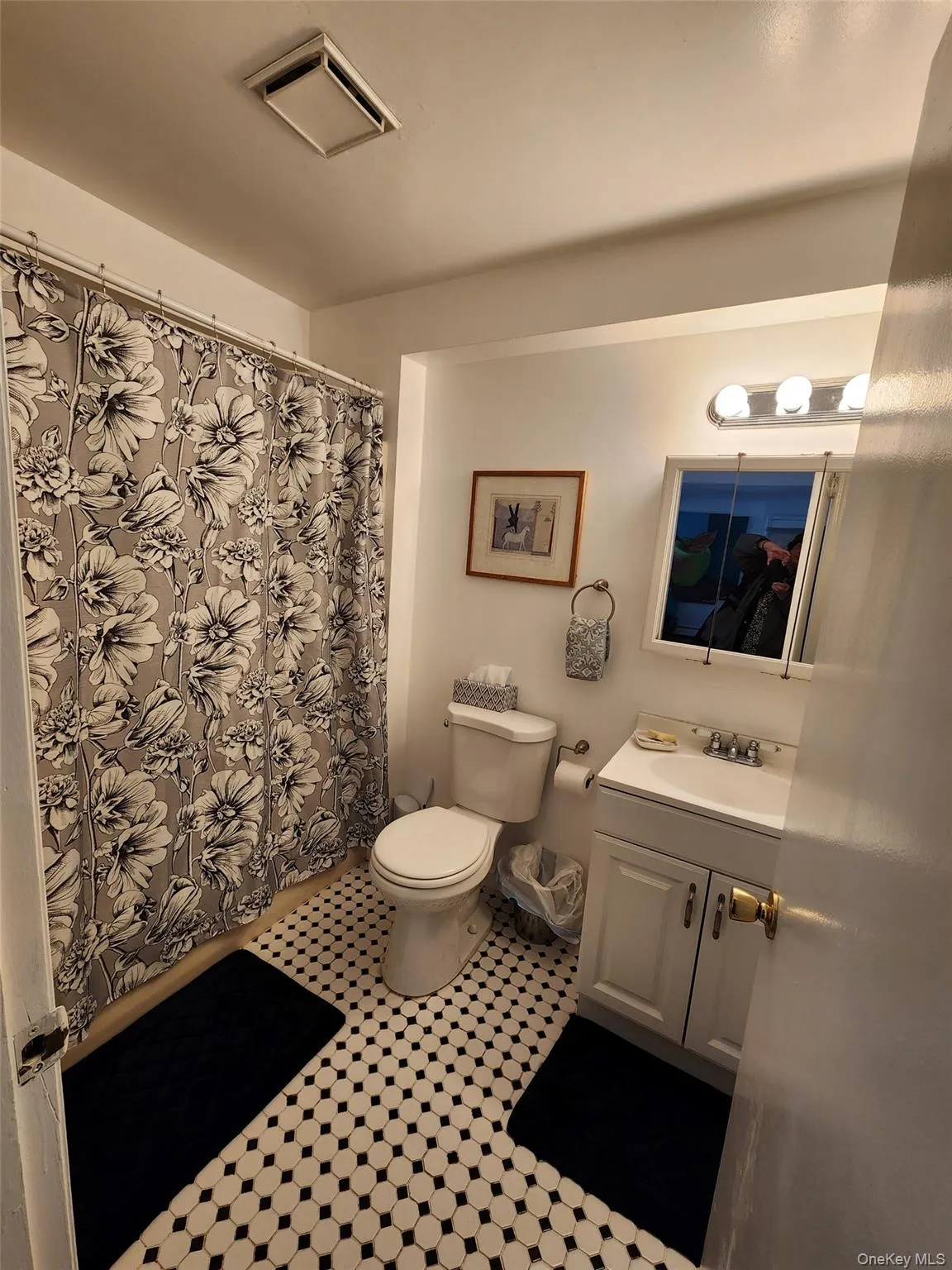 Bathroom with vanity, a shower with curtain, and light tile patterned flooring Bathroom with vanity, a shower with curtain, and light tile patterned flooring