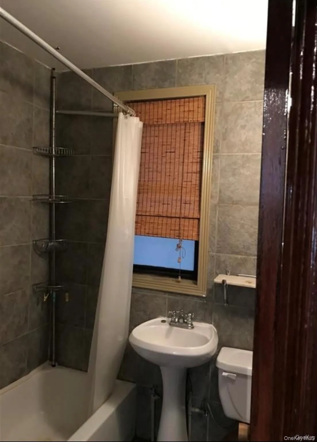 Full bath featuring tile walls and shower / bath combo Full bath featuring tile walls and shower / bath combo