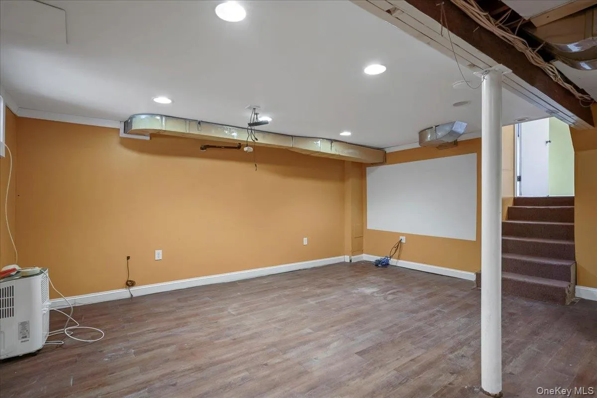 Basement with wood-type flooring and crown molding Basement with wood-type flooring and crown molding