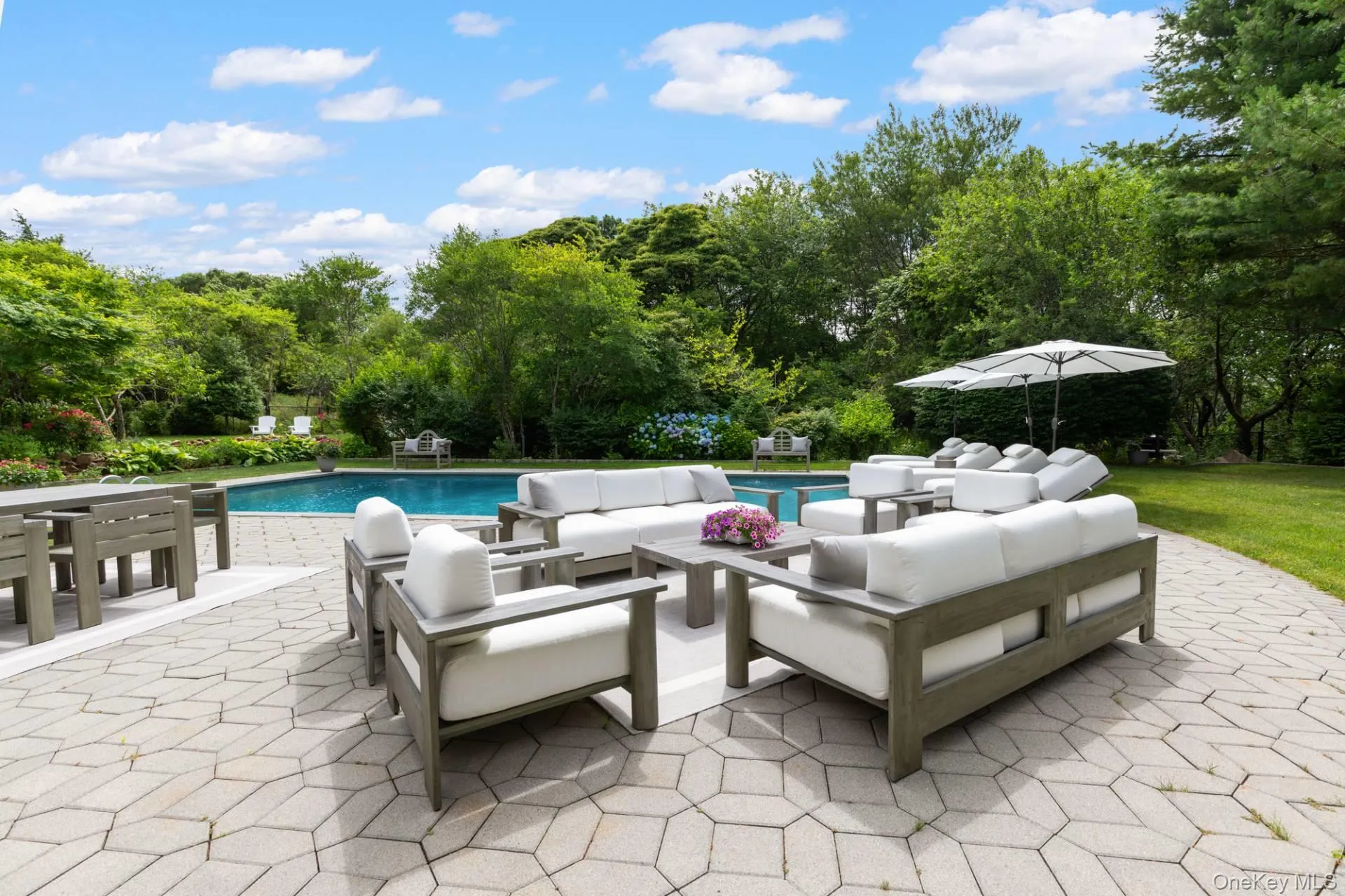 Swimming pool featuring a patio and an outdoor hangout area Swimming pool featuring a patio and an outdoor hangout area