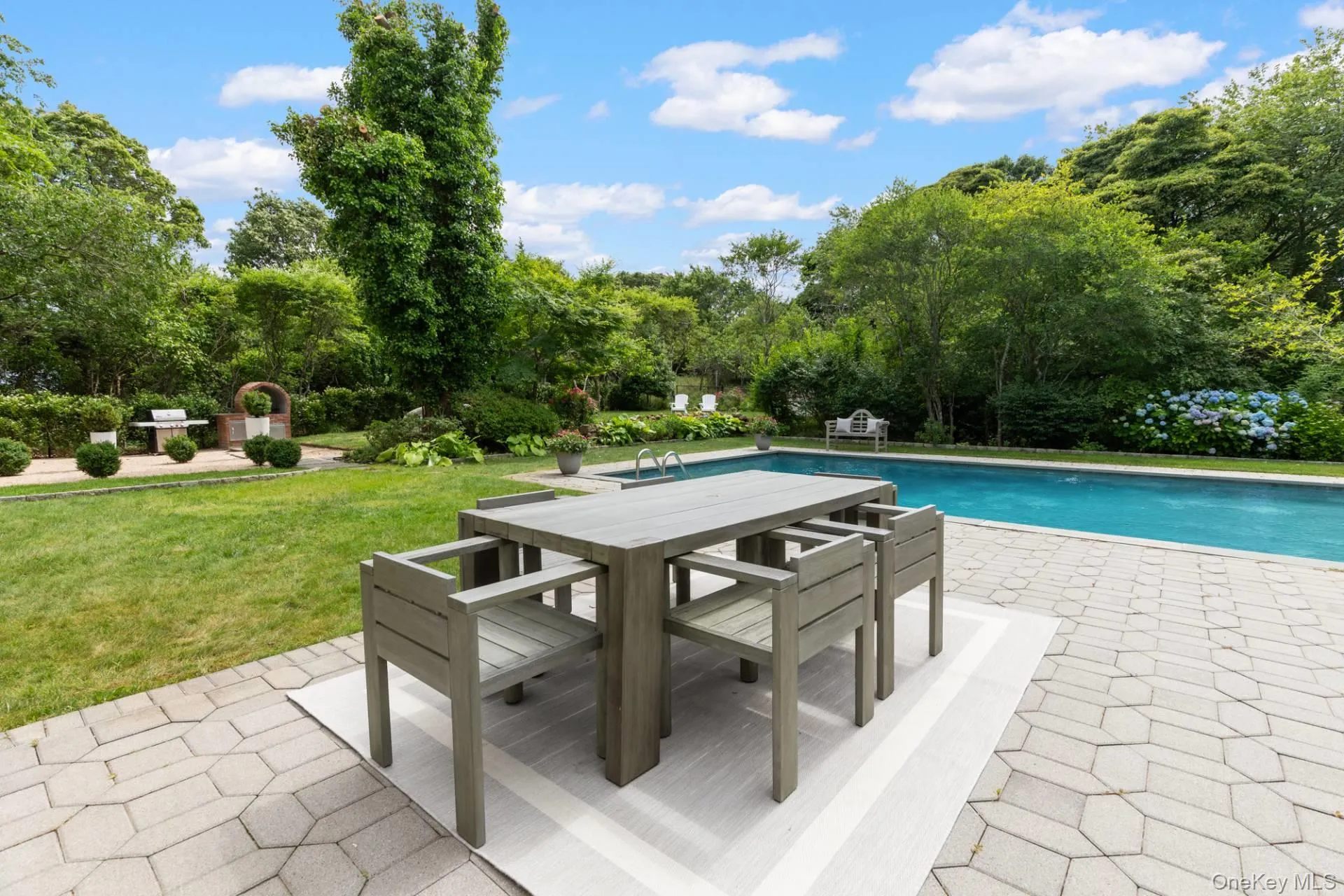 Swimming pool featuring a patio area, a yard, and outdoor dining area Swimming pool featuring a patio area, a yard, and outdoor dining area